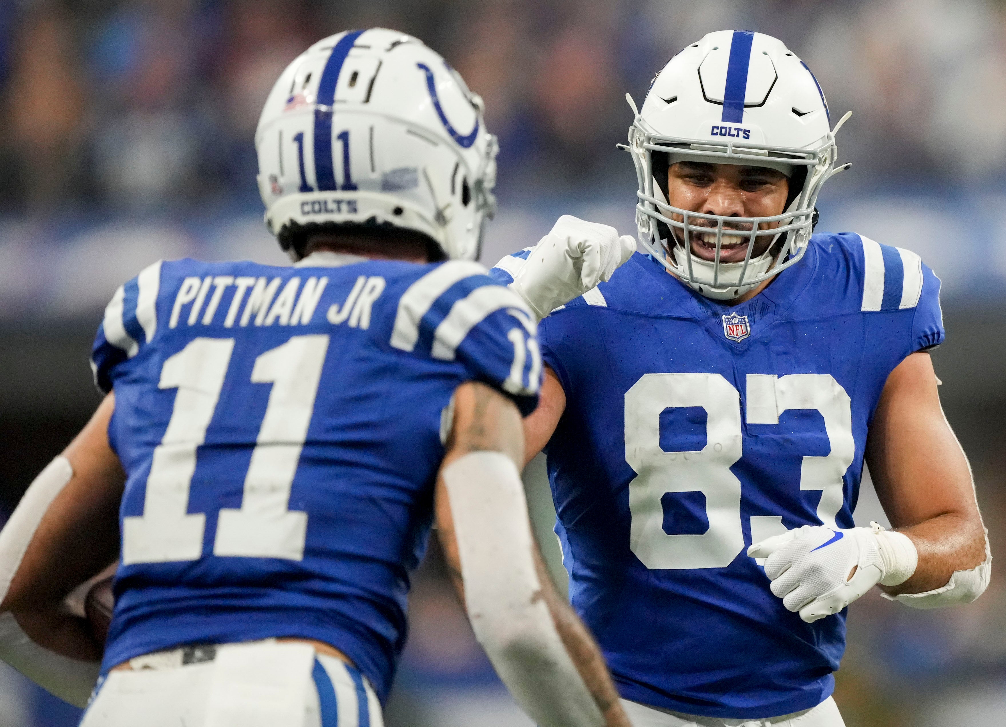 Dec 31, 2023; Indianapolis, Indiana, USA; Indianapolis Colts tight end Kylen Granson (83) celebrates a play with Indianapolis Colts wide receiver Michael Pittman Jr. (11) during a game against the Las Vegas Raiders at Lucas Oil Stadium.