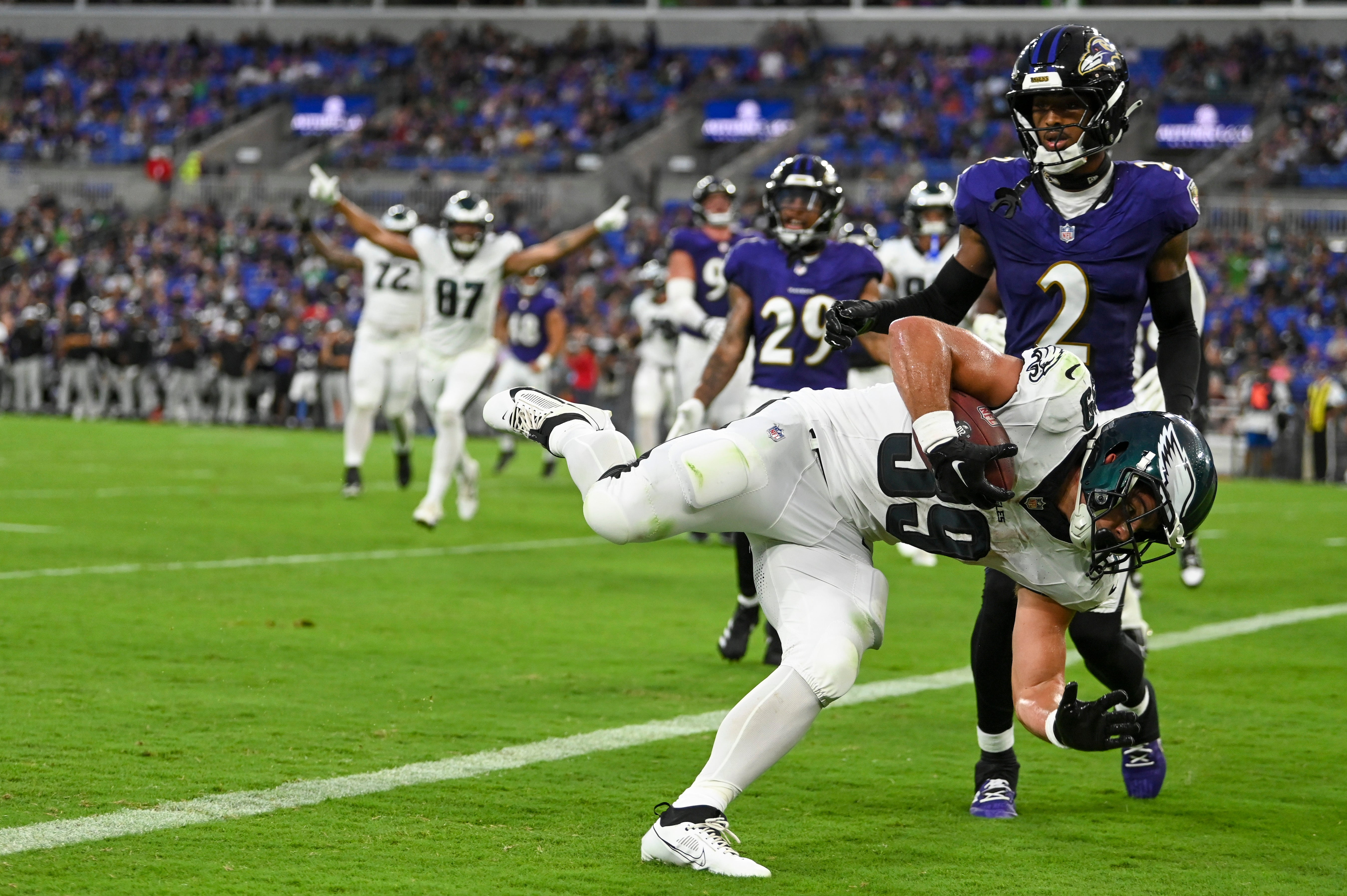 Philadelphia Eagles running back Will Shipley (39) dives in front of Baltimore Ravens cornerback Nate Wiggins (2) for a touchdown during the second quarter of a preseason game at M&T Bank Stadium.