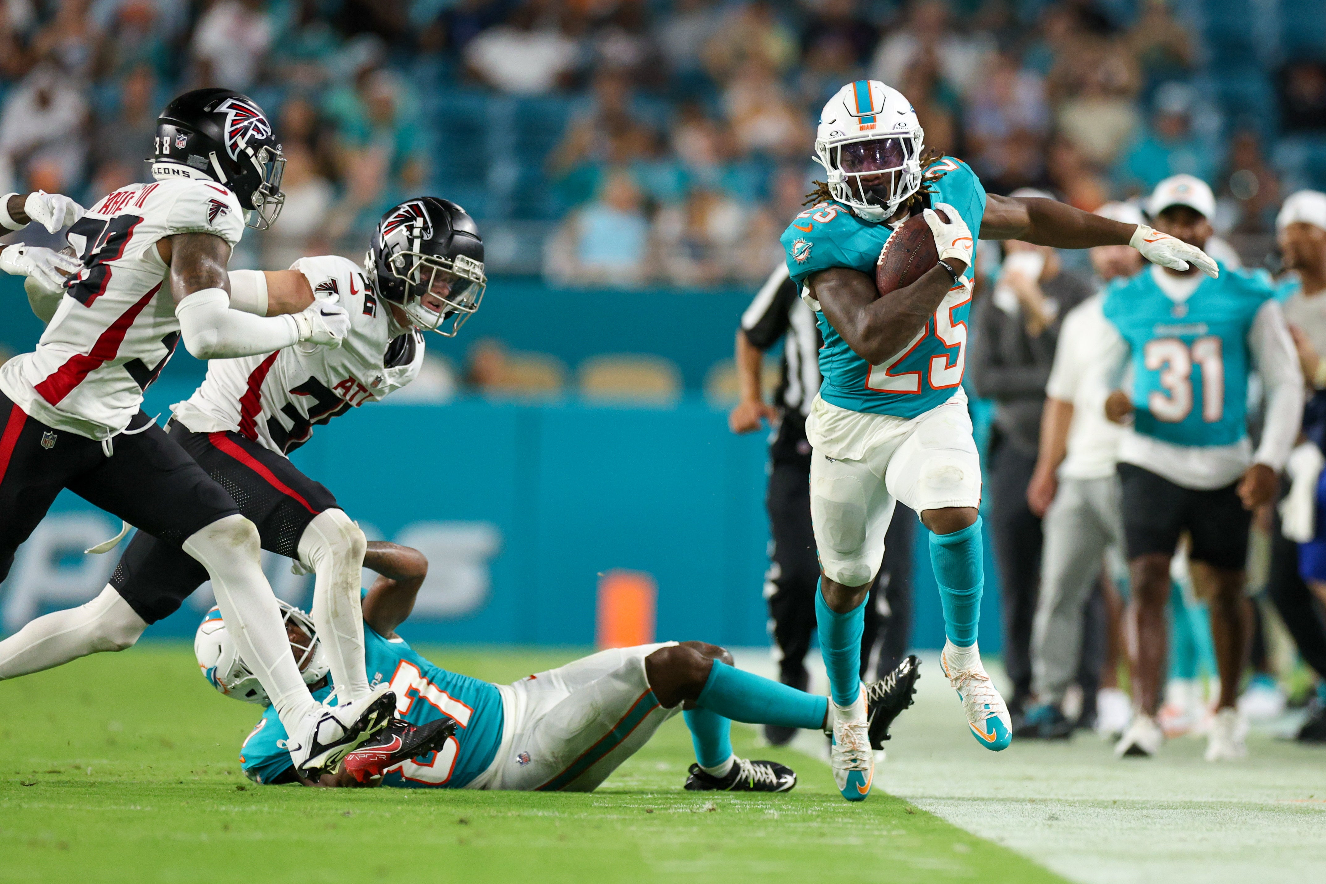 Aug 9, 2024; Miami Gardens, Florida, USA; Miami Dolphins running back Jaylen Wright (25) runs down the sideline against the Atlanta Falcons in the third quarter during preseason at Hard Rock Stadium.