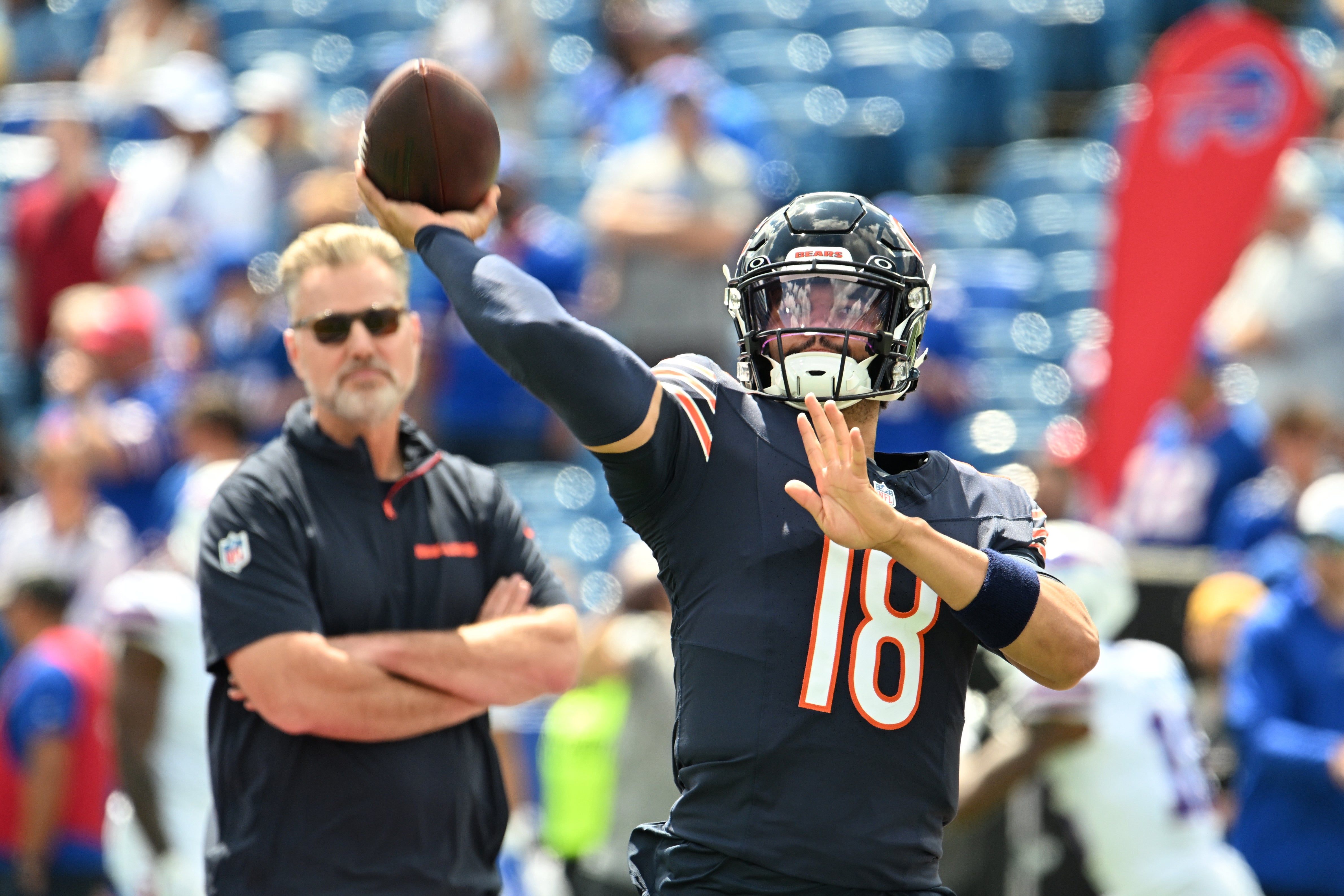 Aug 10, 2024; Orchard Park, New York, USA; Chicago Bears quarterback Caleb Williams (18) throws a pass in warm ups with head coach Matt Eberflus looking on before a pre-season game against the Buffalo Bills at Highmark Stadium.