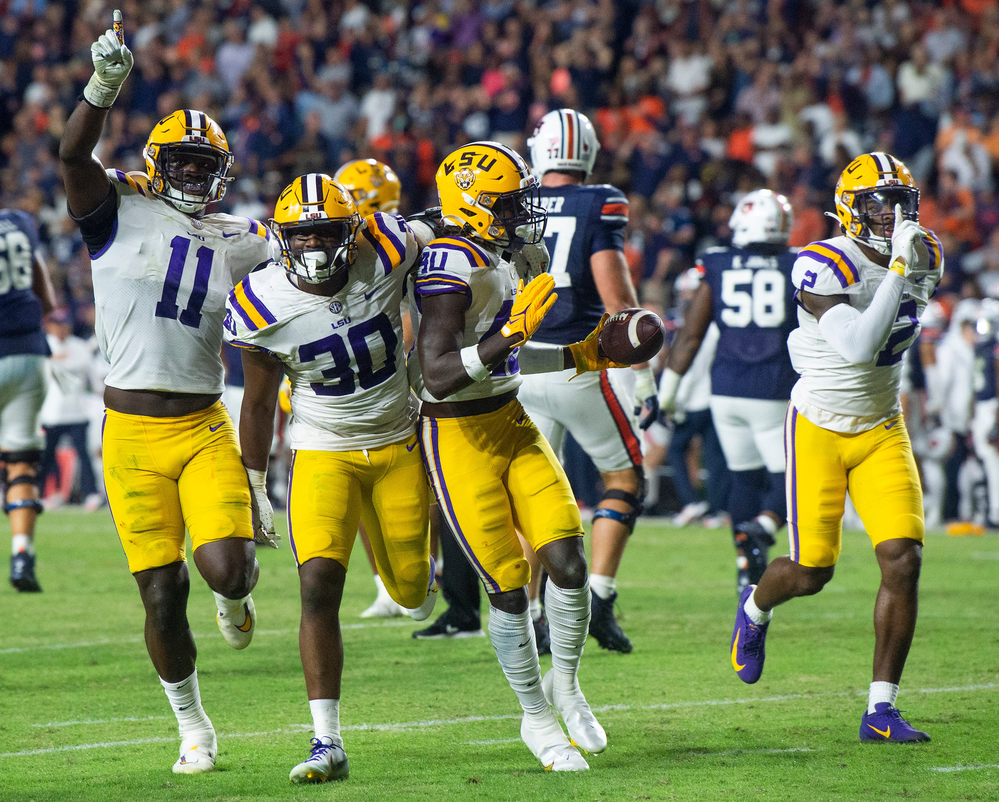 LSU defense celebrates with Harold Perkins at the center of the action