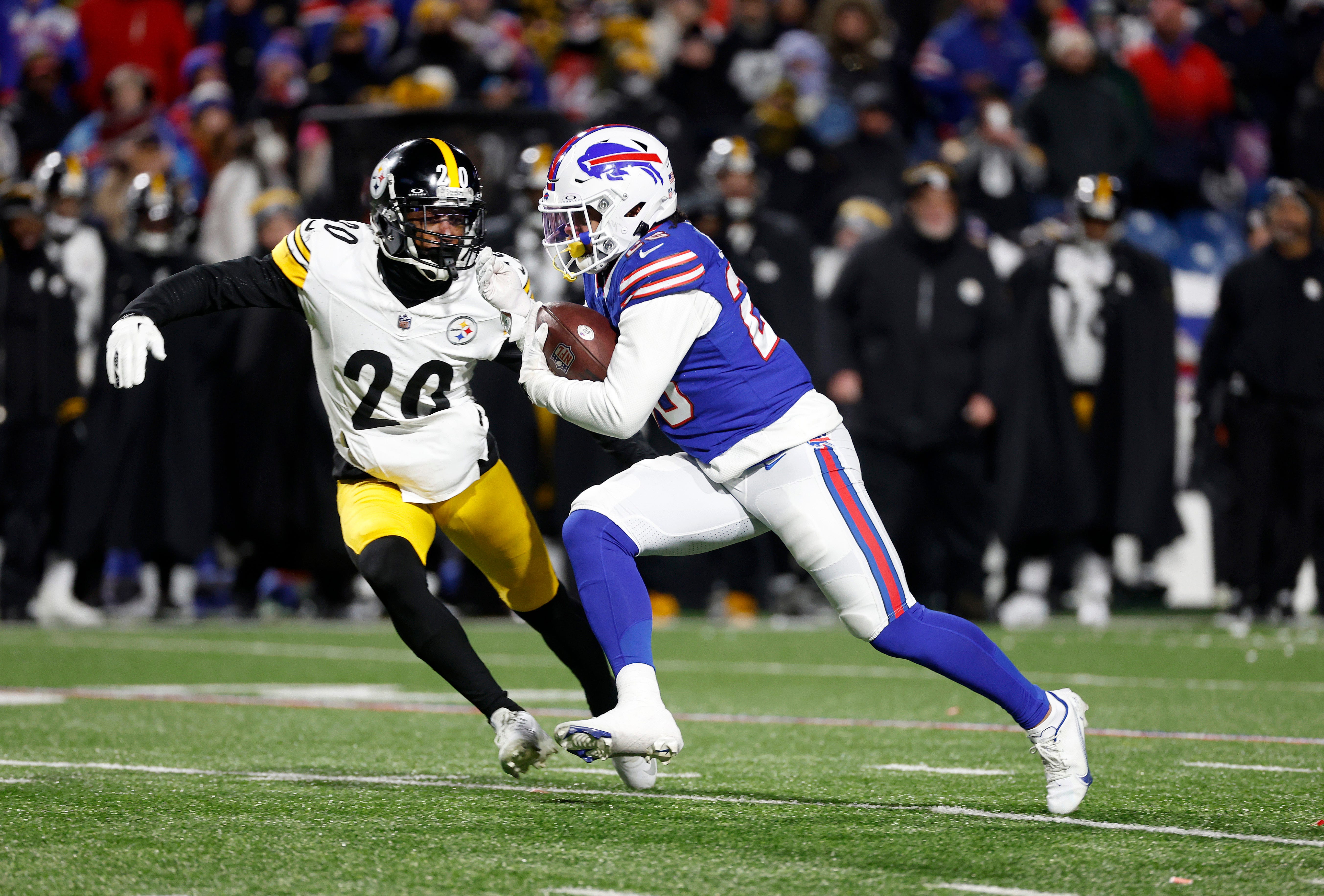Buffalo Bills running back Ty Johnson (26) tries to avoid the tackle by Pittsburgh Steelers cornerback Patrick Peterson (20).