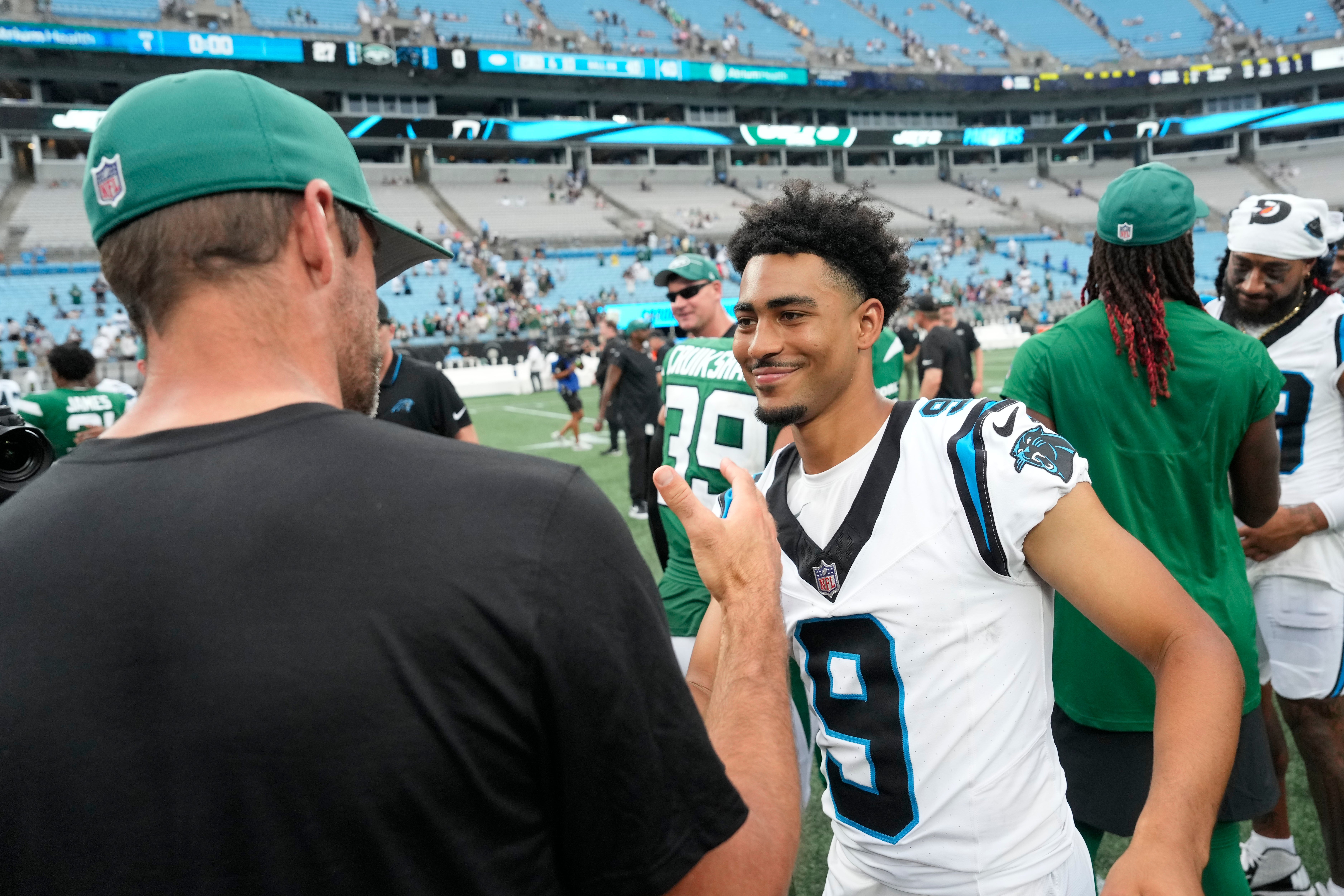 New York Jets quarterback Aaron Rodgers (8) with Carolina Panthers quarterback Bryce Young (9) after the game at Bank of America Stadium.