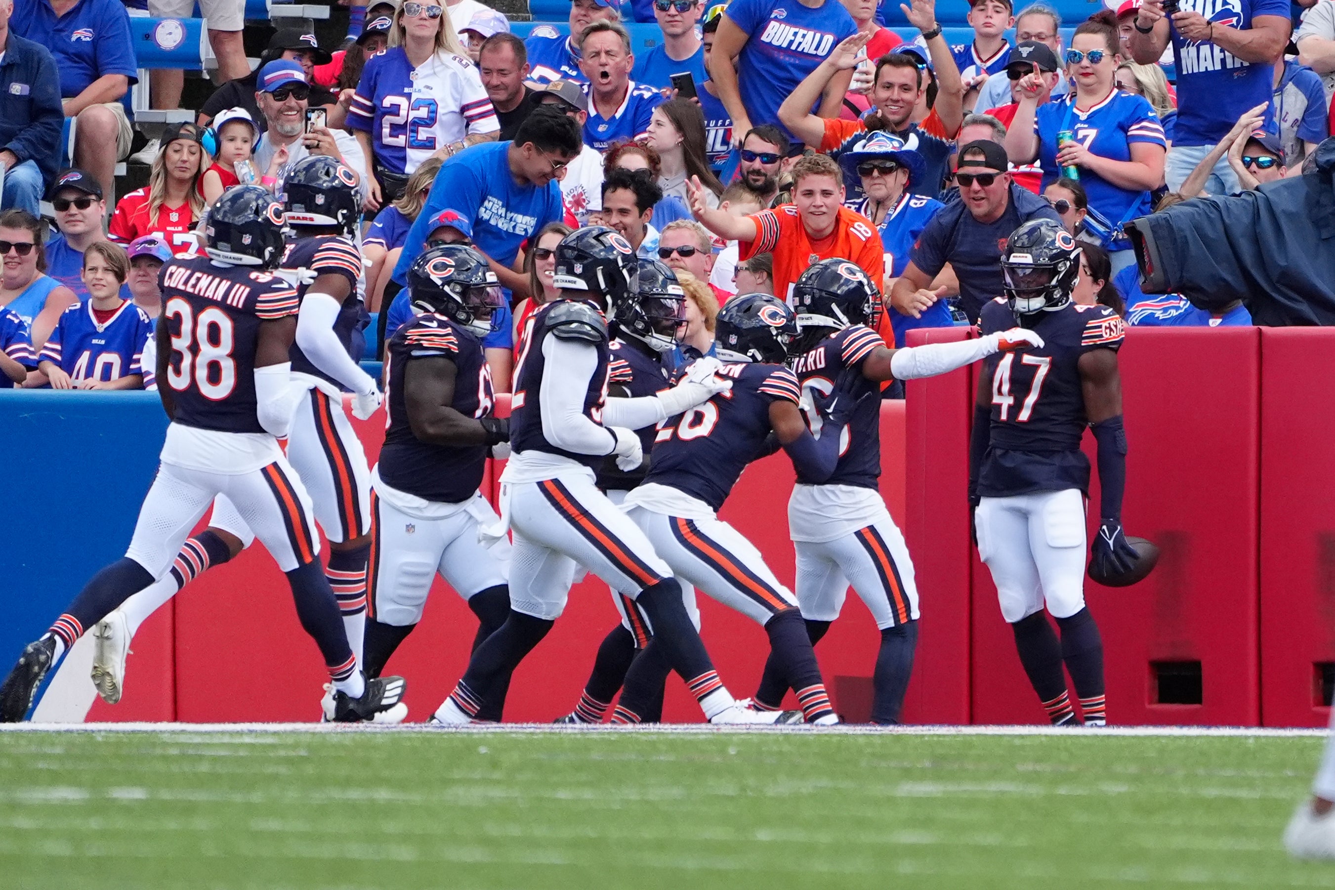 Aug 10, 2024; Orchard Park, New York, USA; Chicago Bears linebacker Micah Baskerville (47) is congratulated by teammates for intercepting a pass and scoring a touchdown against the Buffalo Bills during the second half at Highmark Stadium.