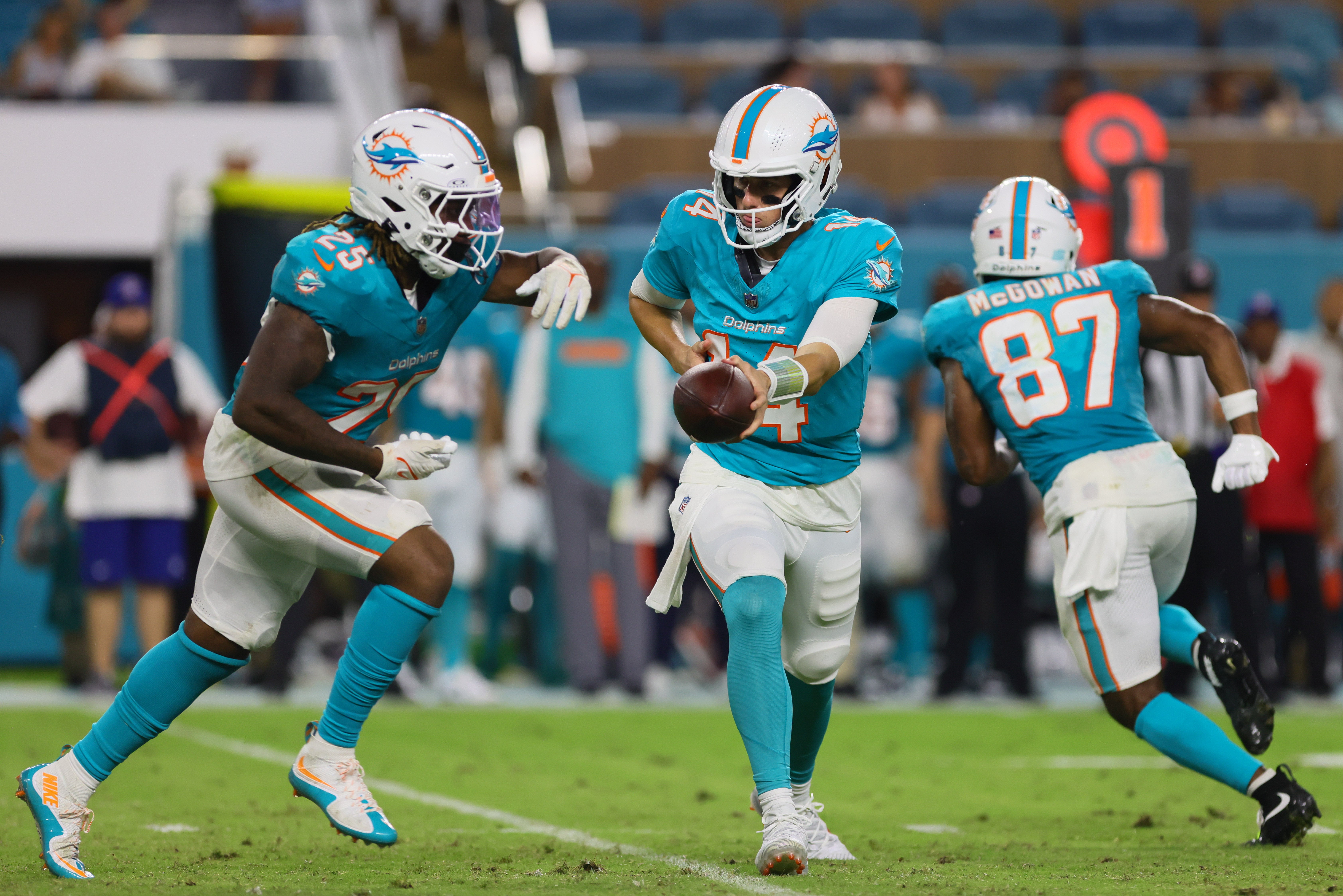Aug 9, 2024; Miami Gardens, Florida, USA; Miami Dolphins quarterback Mike White (14) hands off the football to running back Jaylen Wright (25) against the Atlanta Falcons during the third quarter at Hard Rock Stadium.