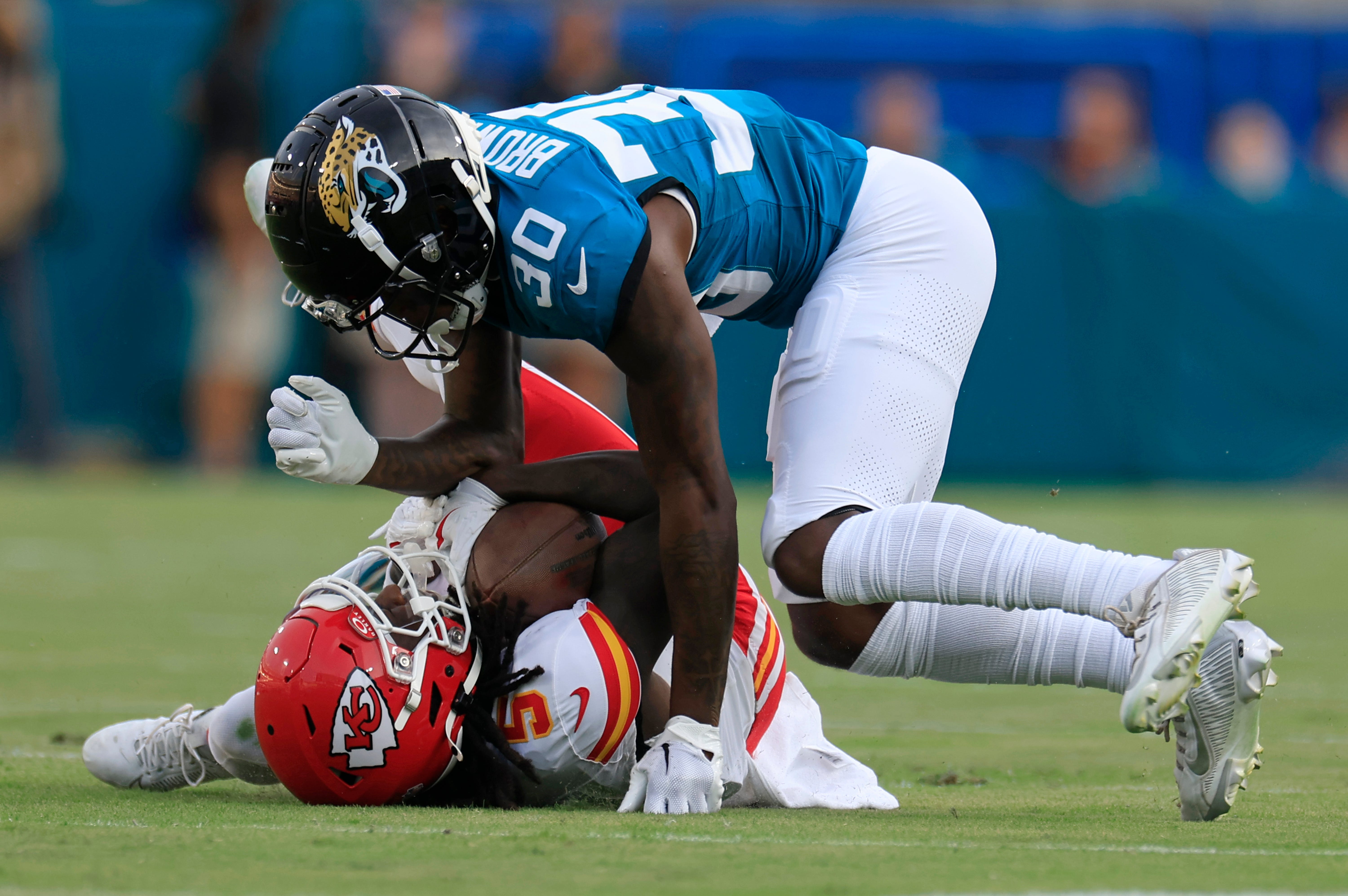 Jacksonville Jaguars cornerback Montaric Brown (30) tackles Kansas City Chiefs wide receiver Hollywood Brown (5) during the first quarter of a preseason NFL football game Saturday, Aug. 10, 2024 at EverBank Stadium in Jacksonville, Fla.
