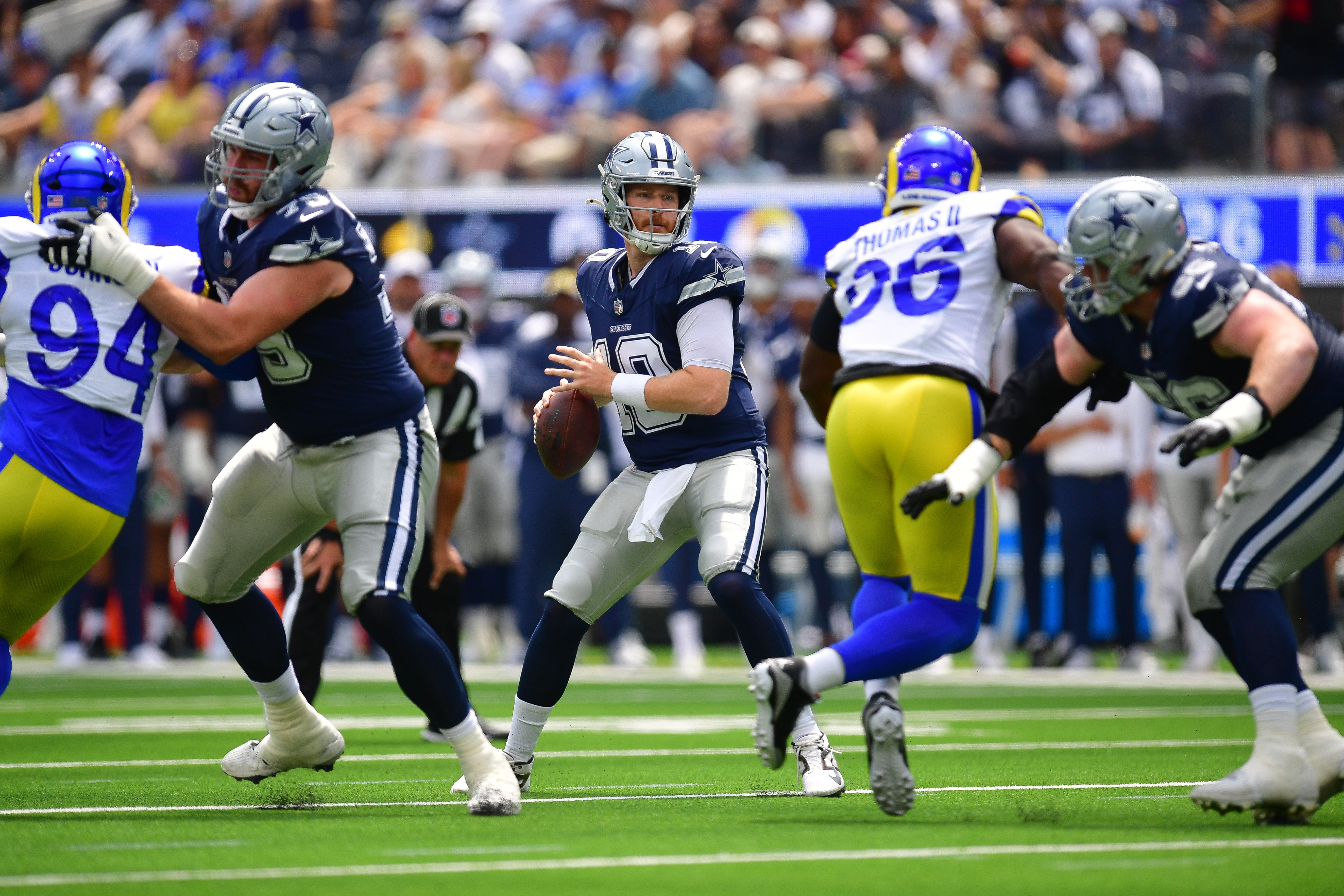 Dallas Cowboys quarterback Cooper Rush (10) drops back to pass against the Los Angeles Rams during the first half at SoFi Stadium.
