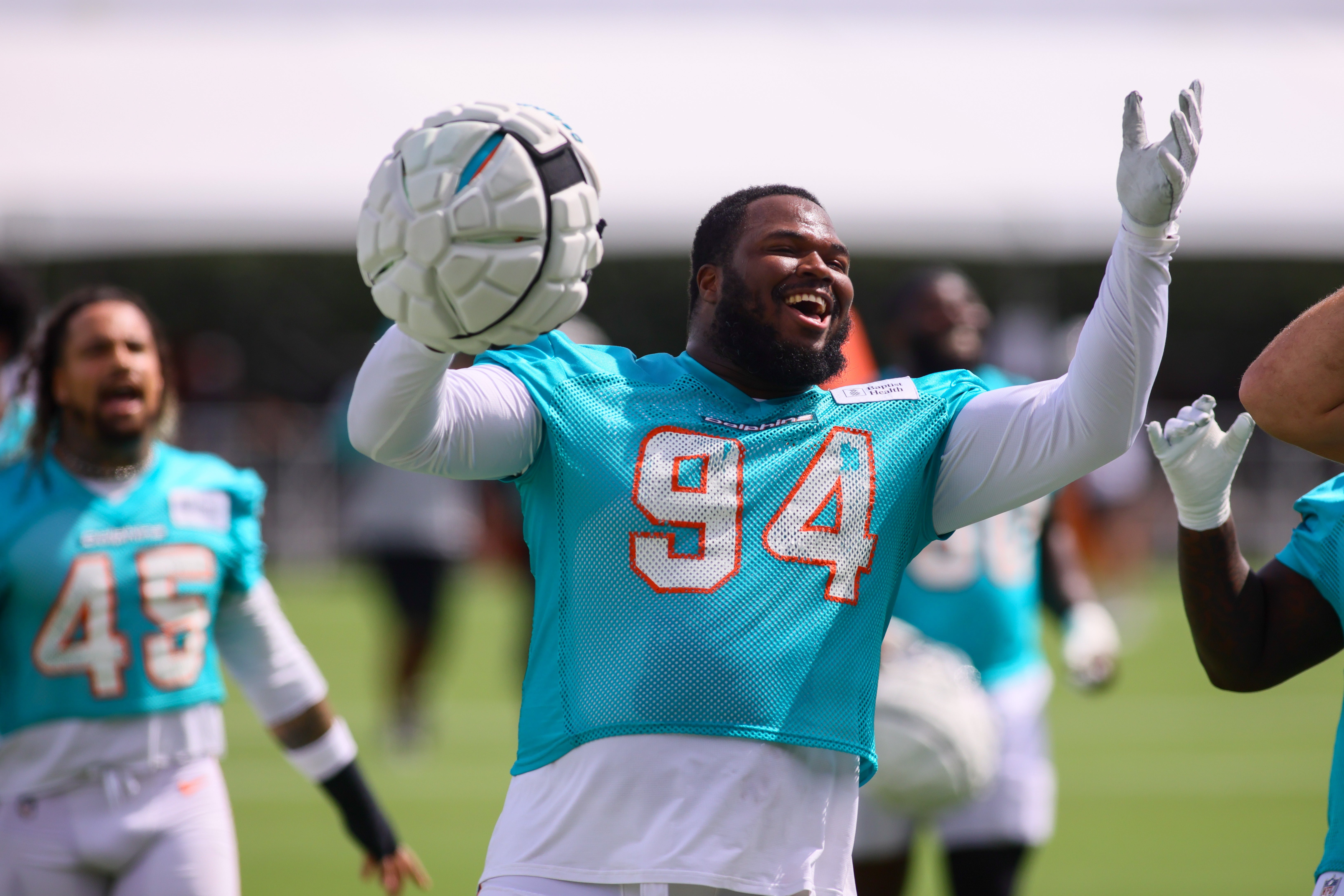 Former Dolphins DT Teair Tart reacts toward the fans during training camp at Baptist Health Training Complex.