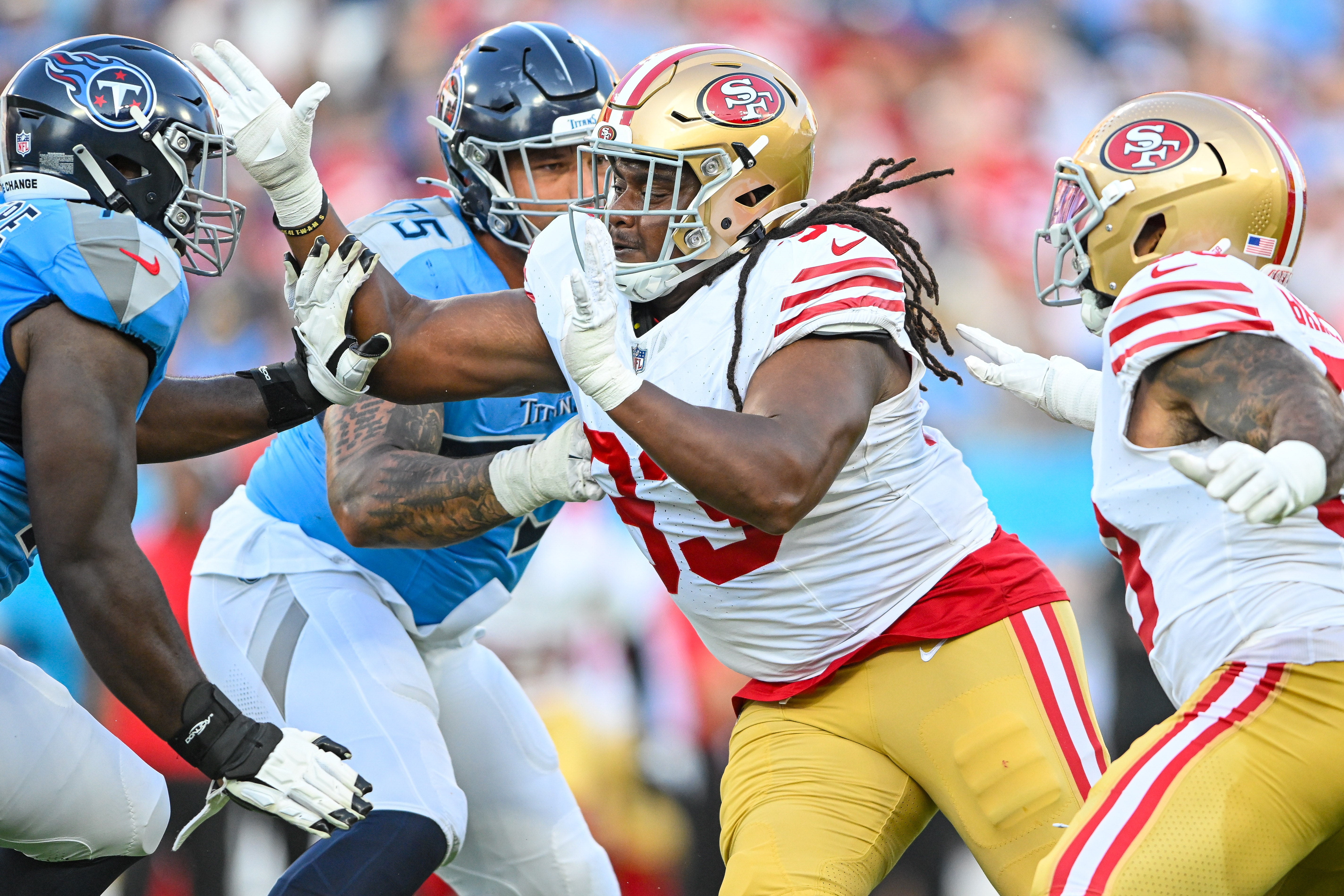 Aug 10, 2024; Nashville, Tennessee, USA; San Francisco 49ers defensive tackle Kalia Davis (93) rushes the quarterback against the Tennessee Titans during the first half at Nissan Stadium.