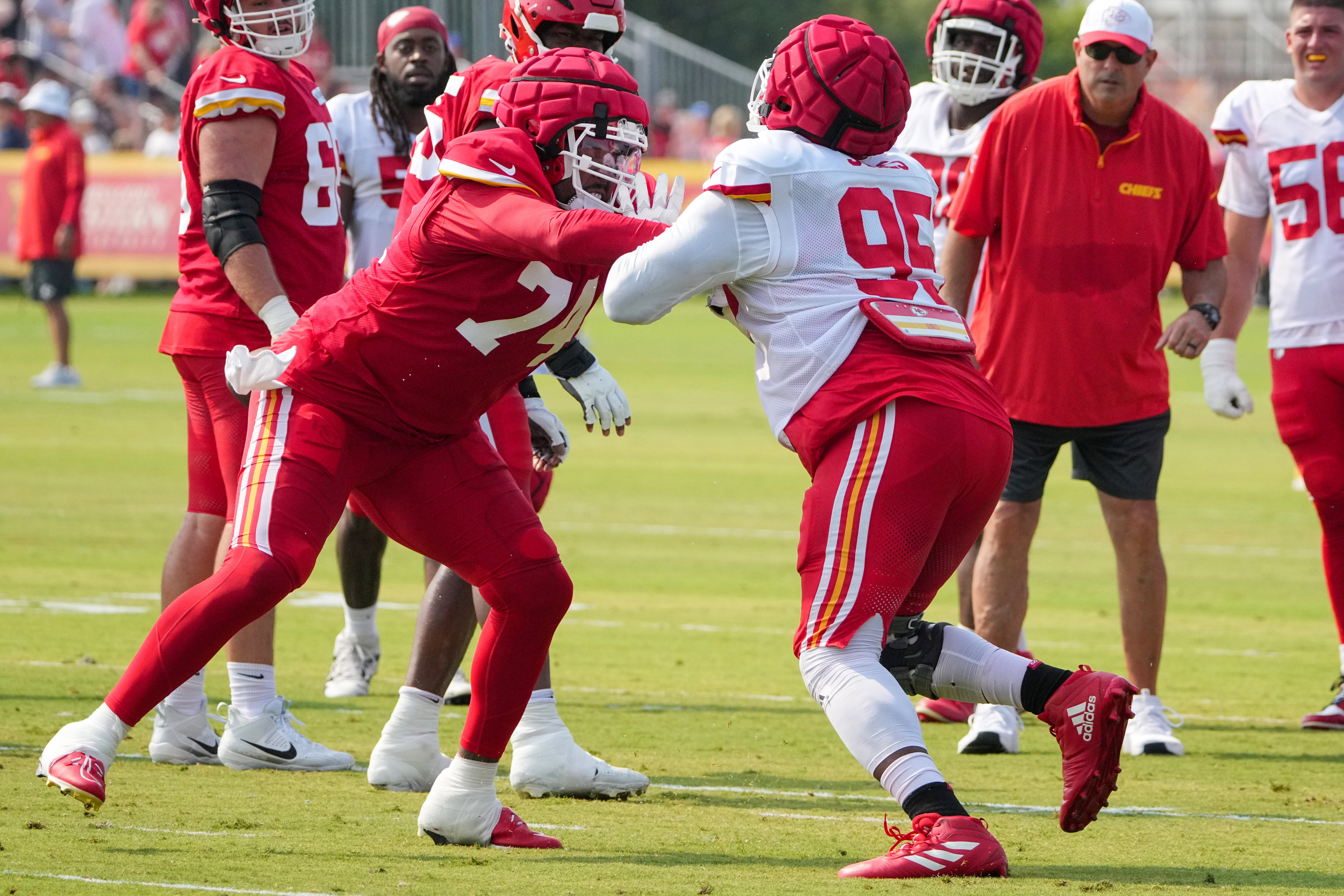 Jul 26, 2024; Kansas City, MO, USA; Kansas City Chiefs offensive tackle Jawaan Taylor (74) and defensive tackle Chris Jones (95) run drills during training camp at Missouri Western State University.