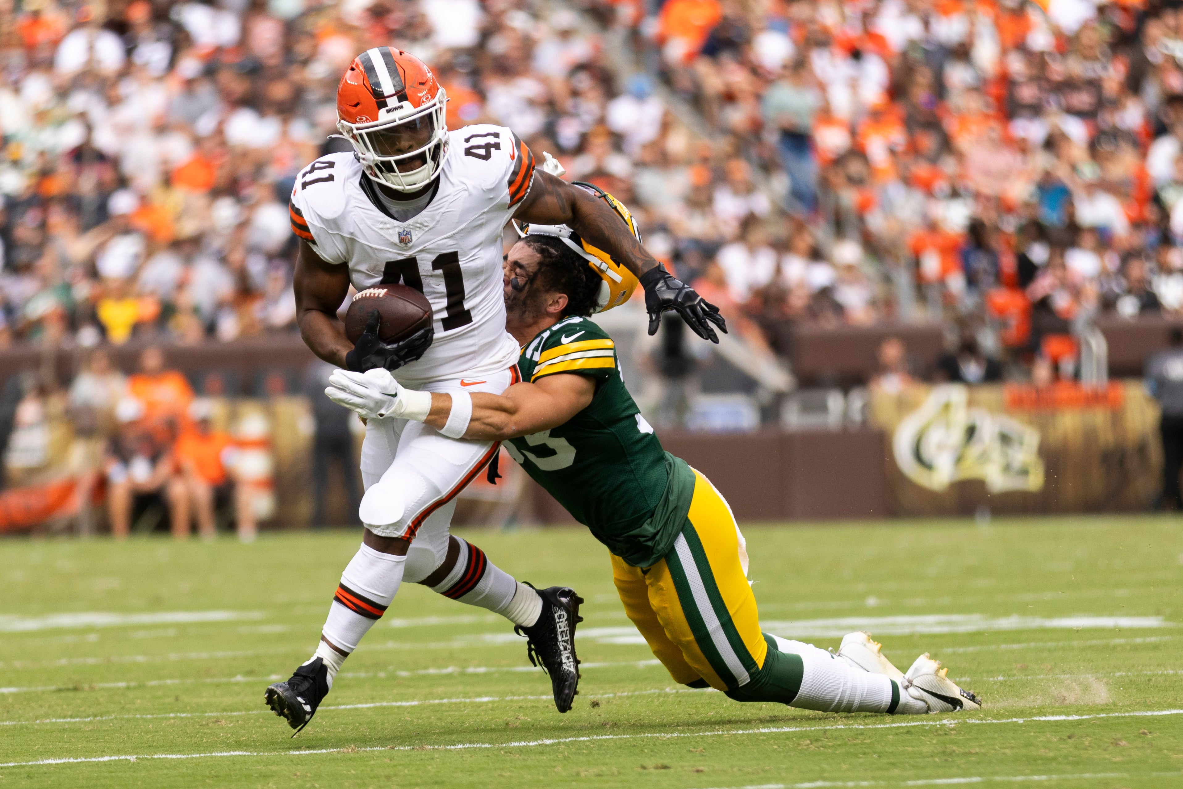 Cleveland Browns running back John Kelly Jr. (41) runs the ball as he is tackled by Green Bay Packers safety Evan Williams (33)