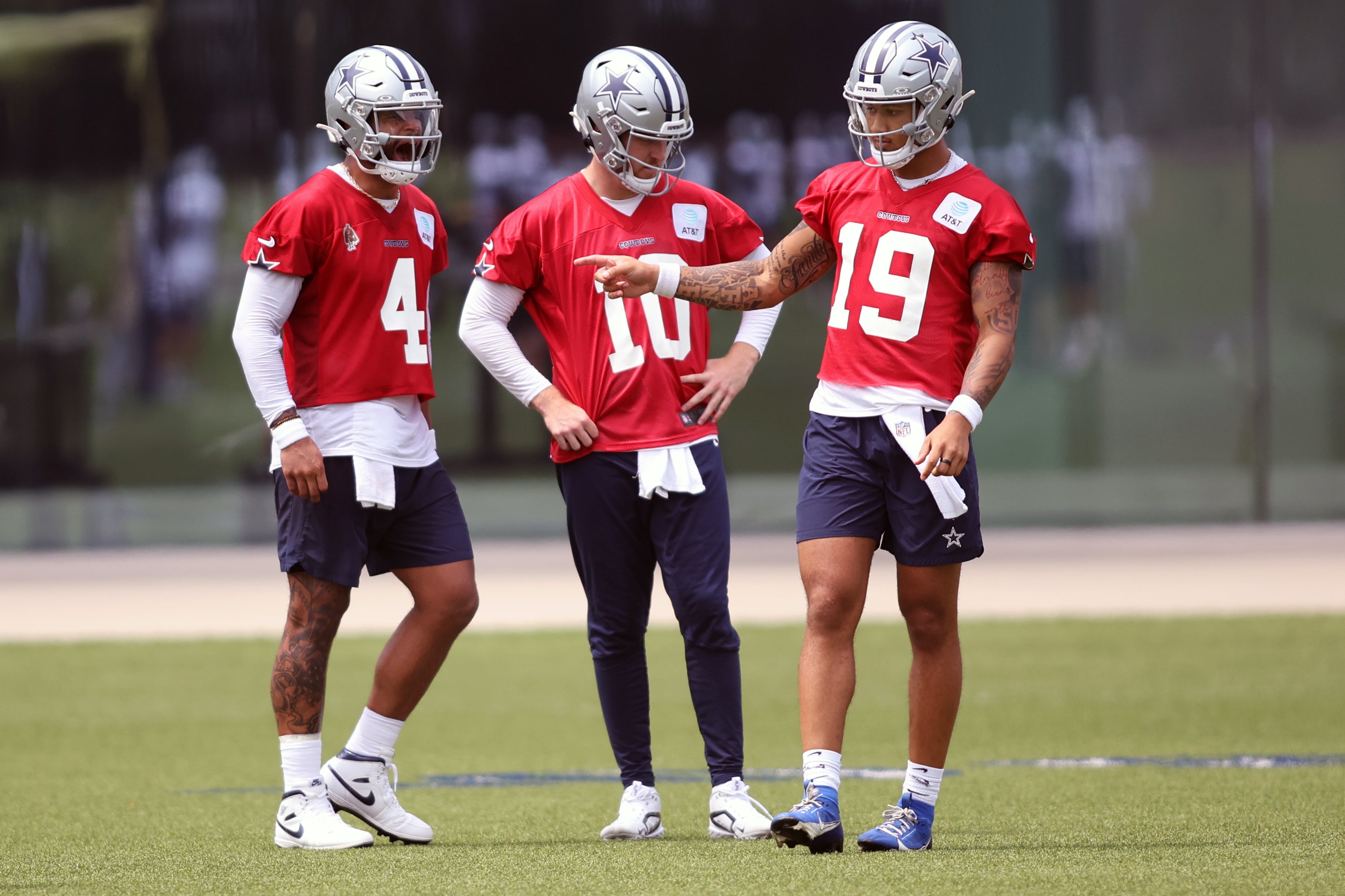Dallas Cowboys quarterback Dak Prescott (4) and quarterback Cooper Rush (10) and quarterback Trey Lance (19) talk during practice at the Ford Center at the Star Training Facility in Frisco, Texas.