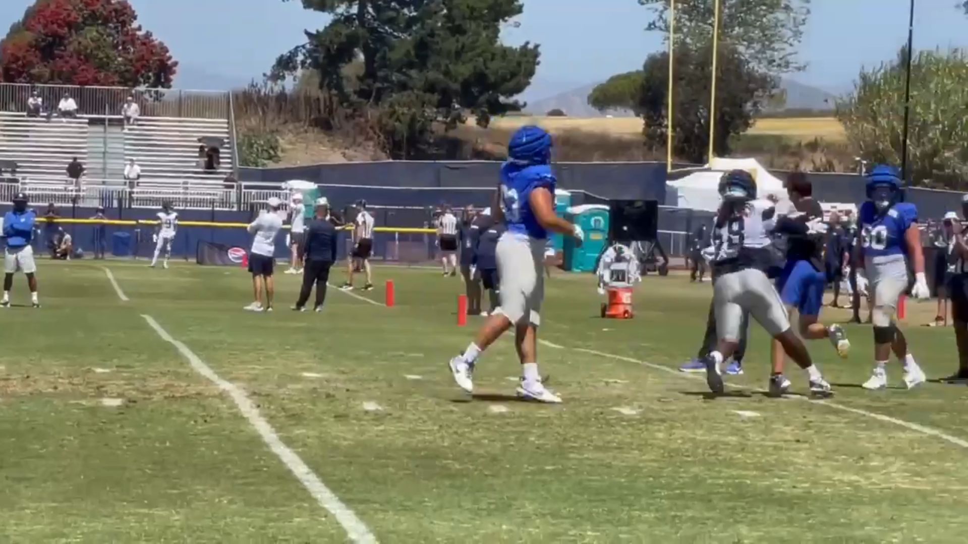 Dallas Cowboys DT Albert Huggins shoves L.A. Rams staff member during joint practice.