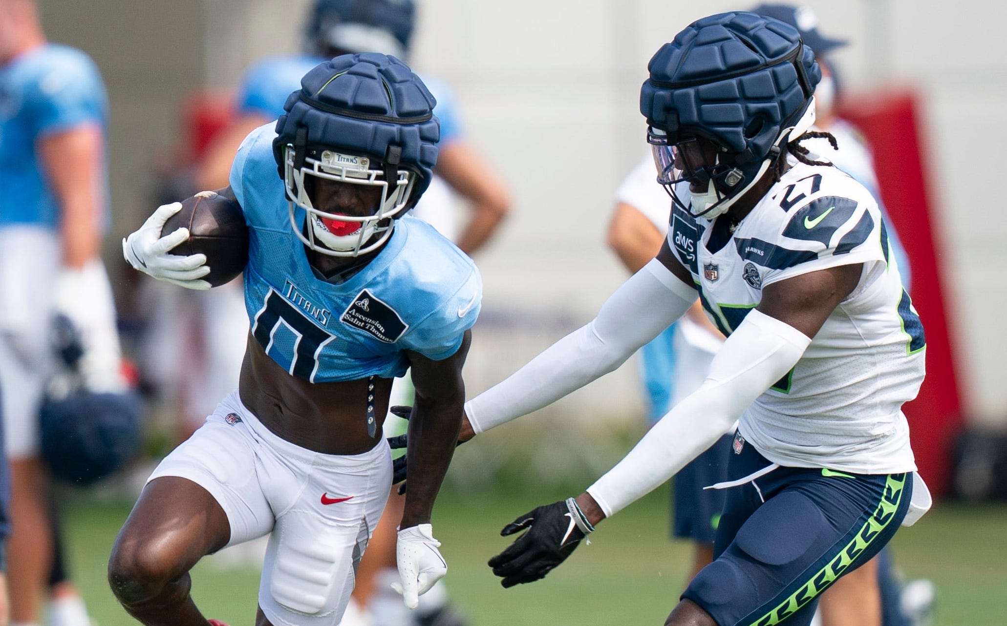 Tennessee Titans wide receiver Calvin Ridley (0) runs after a catch against Seattle Seahawks cornerback Riq Woolen (27) at Ascension Saint Thomas Sports Park in Nashville, Tenn., Wednesday, Aug. 14 20... Denny Simmons / The Tennessean-USA TODAY NETWORK