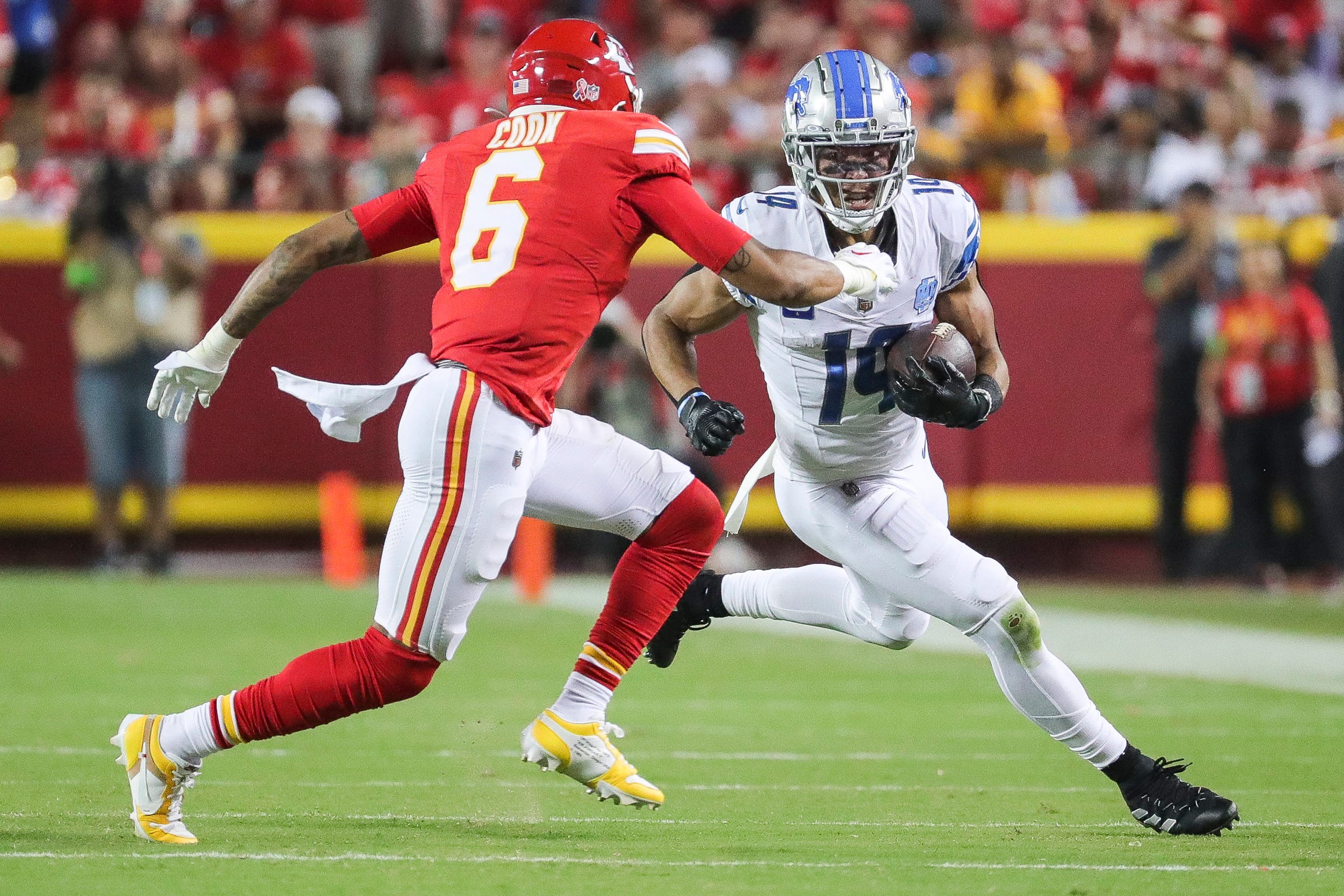 Detroit Lions wide receiver Amon-Ra St. Brown (14) makes a catch against Kansas City Chiefs safety Bryan Cook (6) during the second half at Arrowhead Stadium in Kansas City, Mo. on Thursday, Sept. 7, 2023.