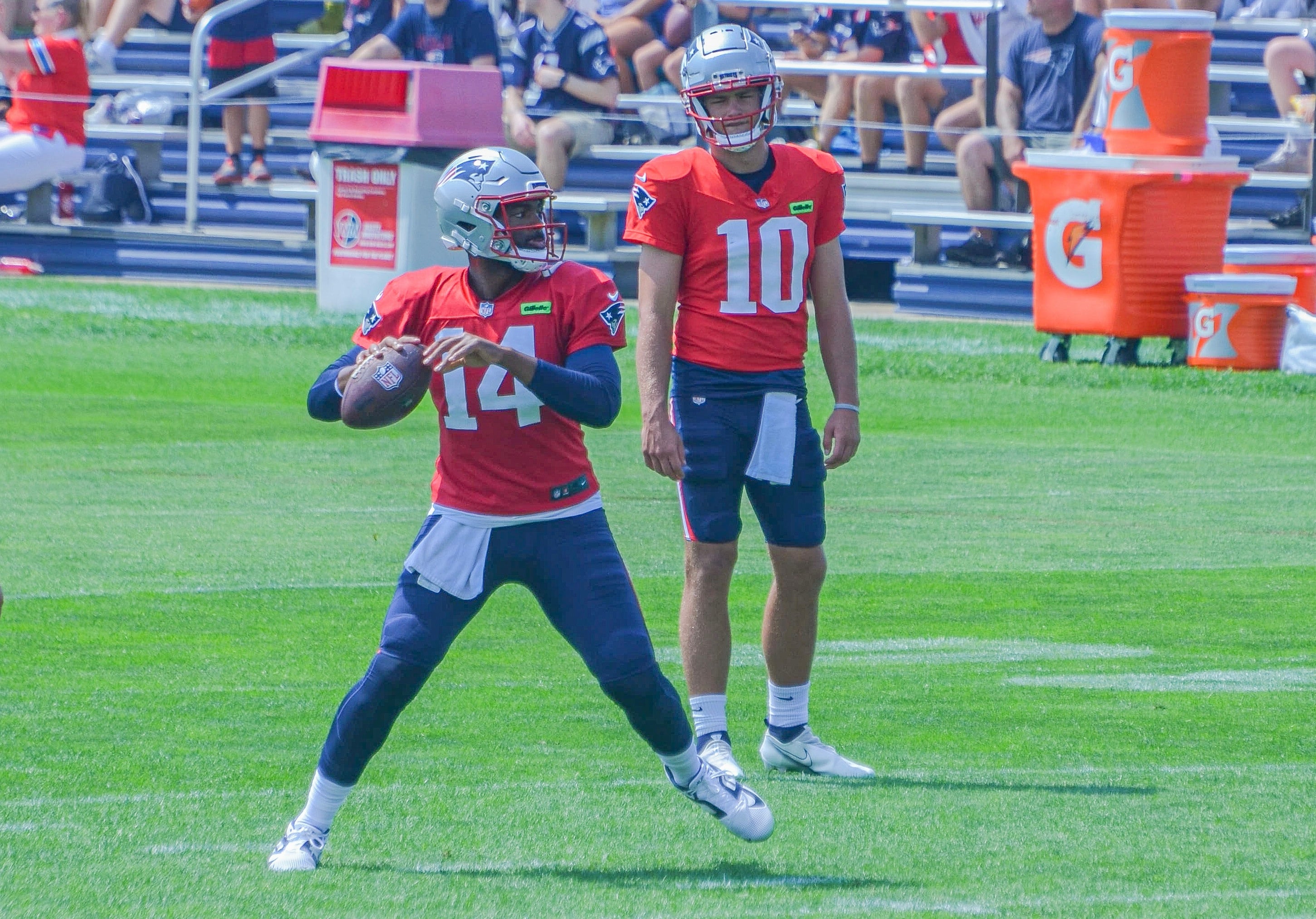 Jacoby Brissett throws the ball while Drake Maye watches during 2024 Patriots Training Camp