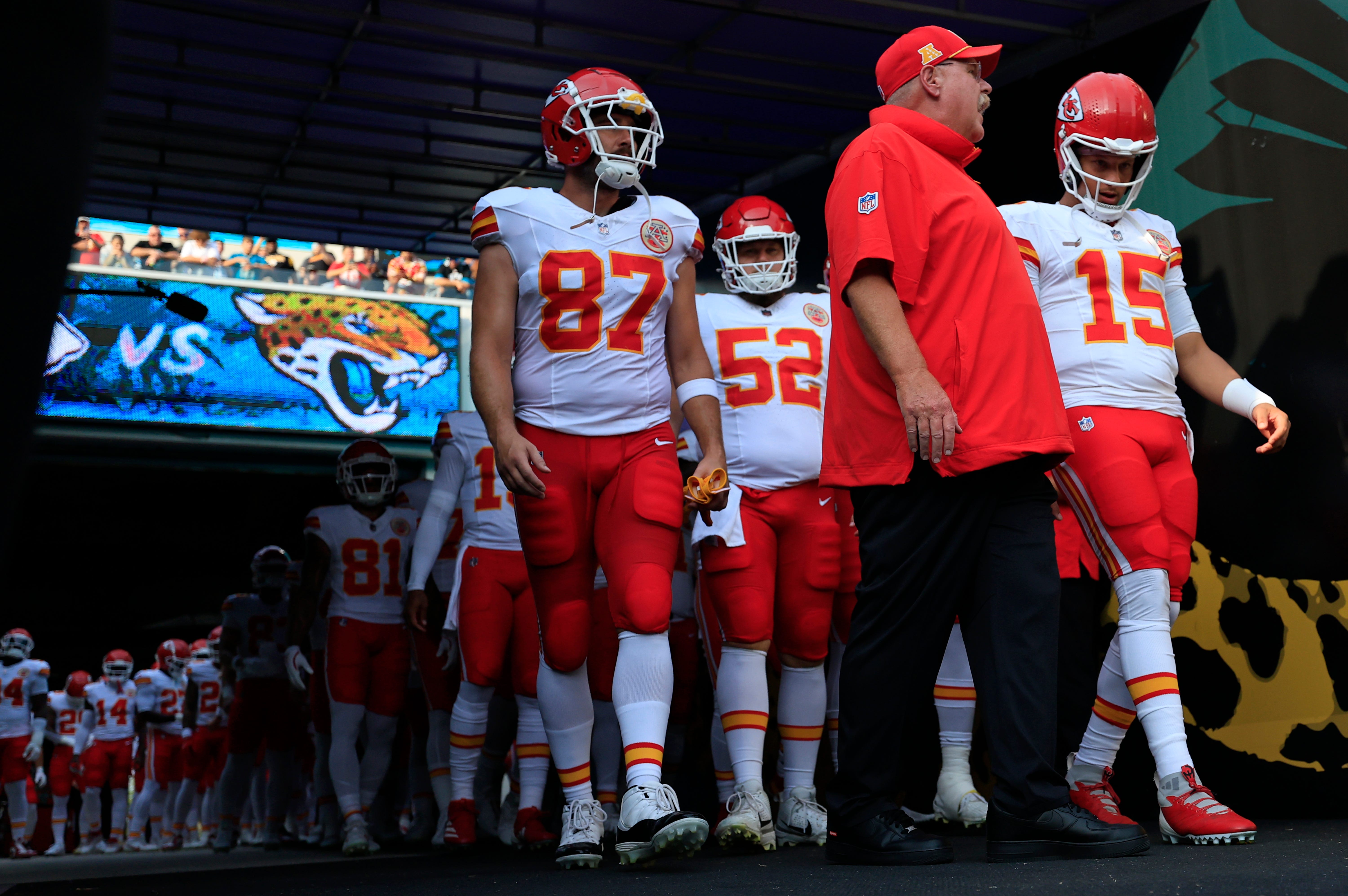 Kansas City Chiefs head coach Andy Reid, center, talks to quarterback Patrick Mahomes (15) next to tight end Travis Kelce (87) before a preseason NFL football game.