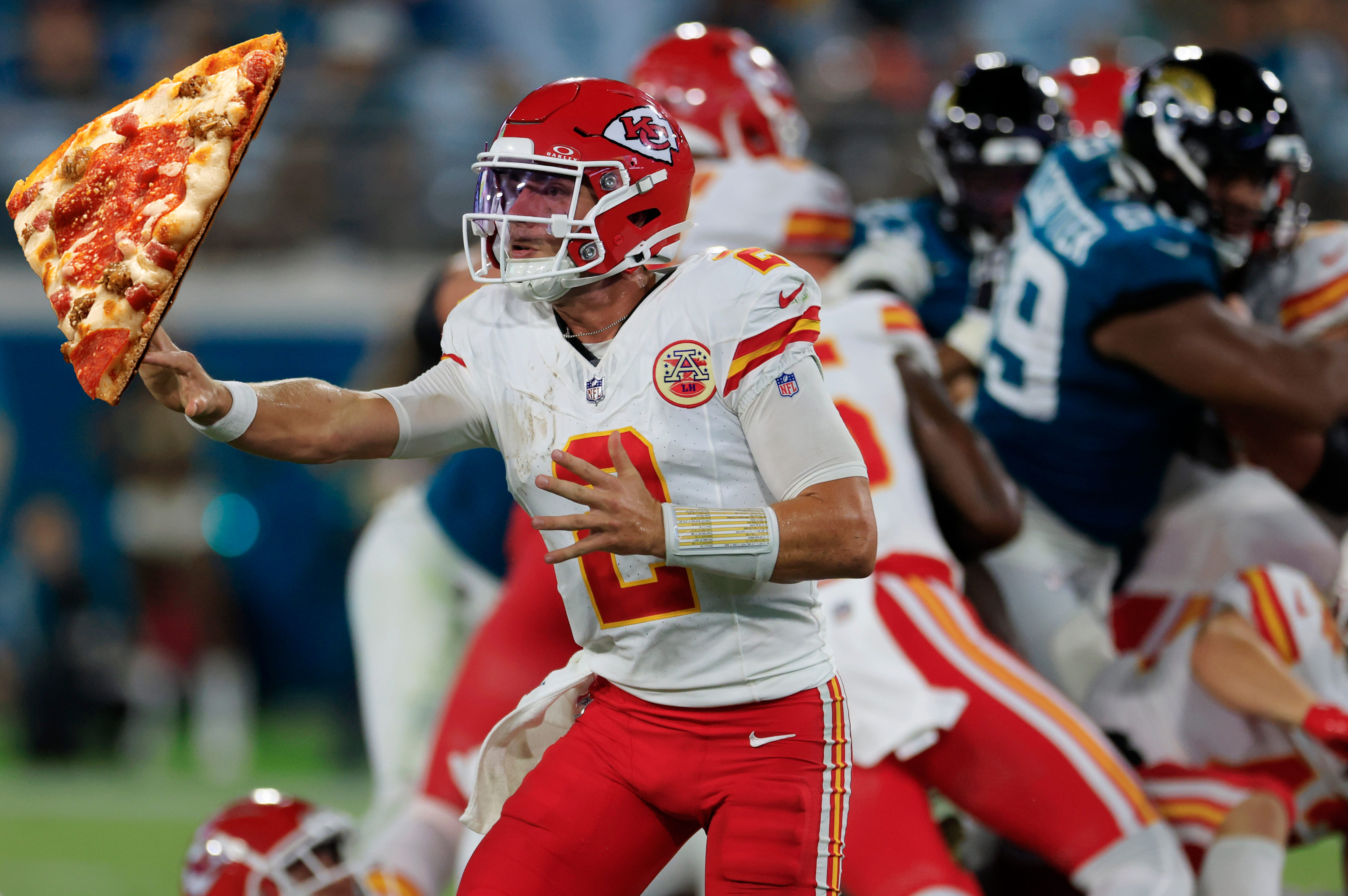 Kansas City Chiefs quarterback Ian Book (2) hits a shovel pass during the fourth quarter of a preseason NFL football game Saturday, Aug. 10, 2024 at EverBank Stadium in Jacksonville, Fla. The Jacksonville Jaguars defeated the Kansas City Chiefs 26-13.