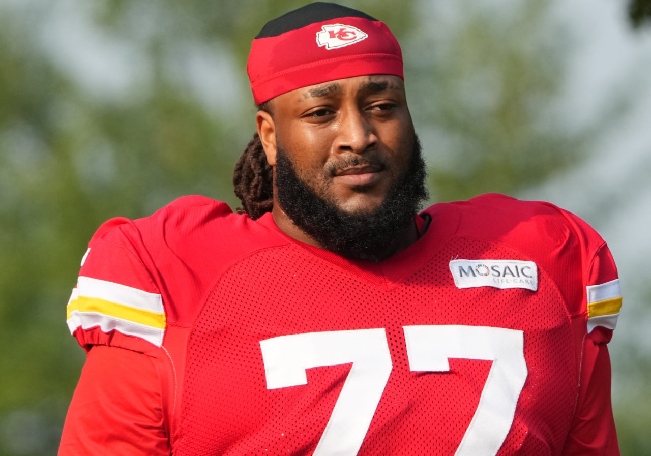 Jul 26, 2024; Kansas City, MO, USA; Kansas City Chiefs offensive tackle Lucas Niang (77) walks from the locker room to the fields prior to training camp at Missouri Western State University.