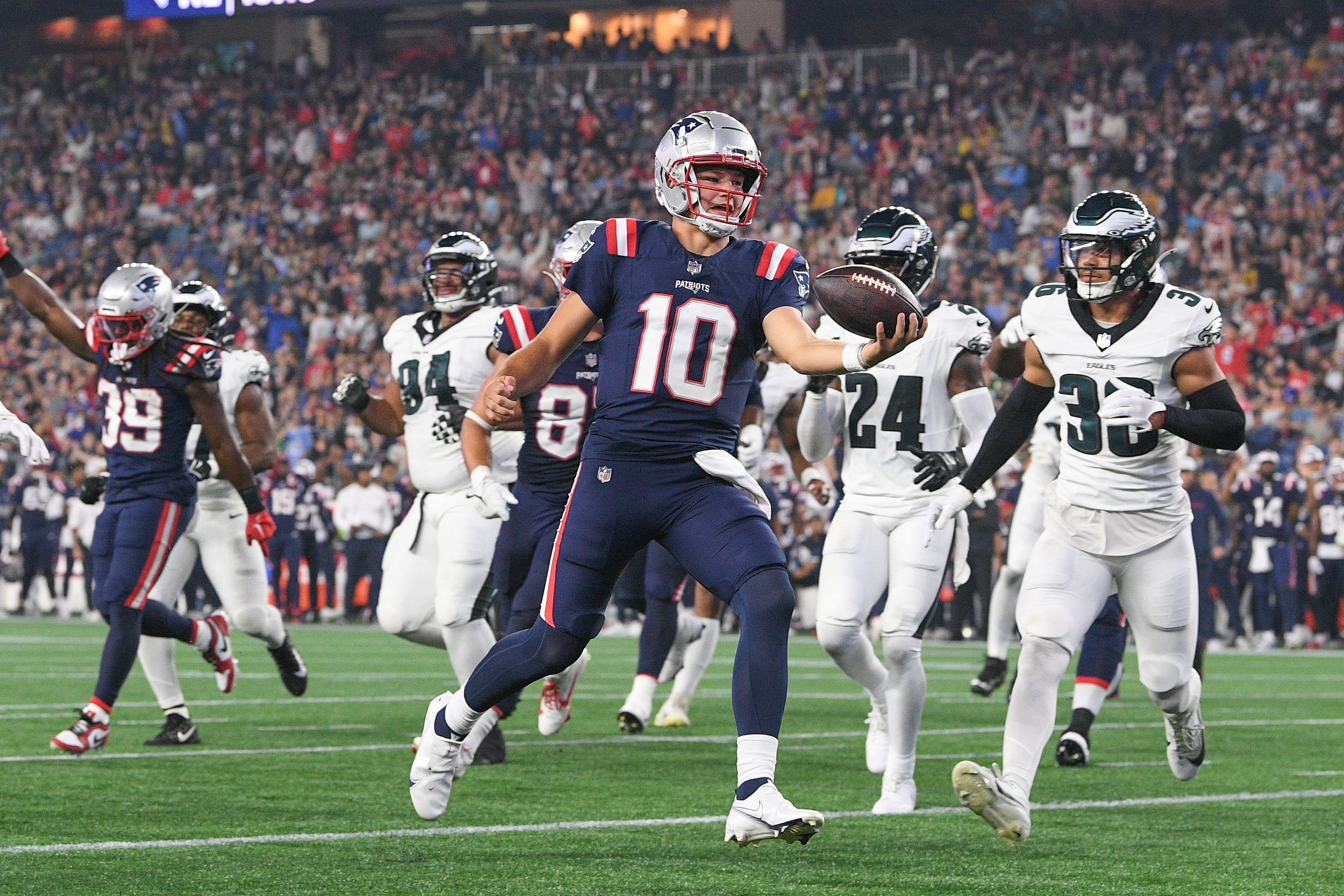Aug 15, 2024; Foxborough, MA, USA; New England Patriots quarterback Drake Maye (10) runs the ball in for a touchdown against the Philadelphia Eagles during the first half at Gillette Stadium.