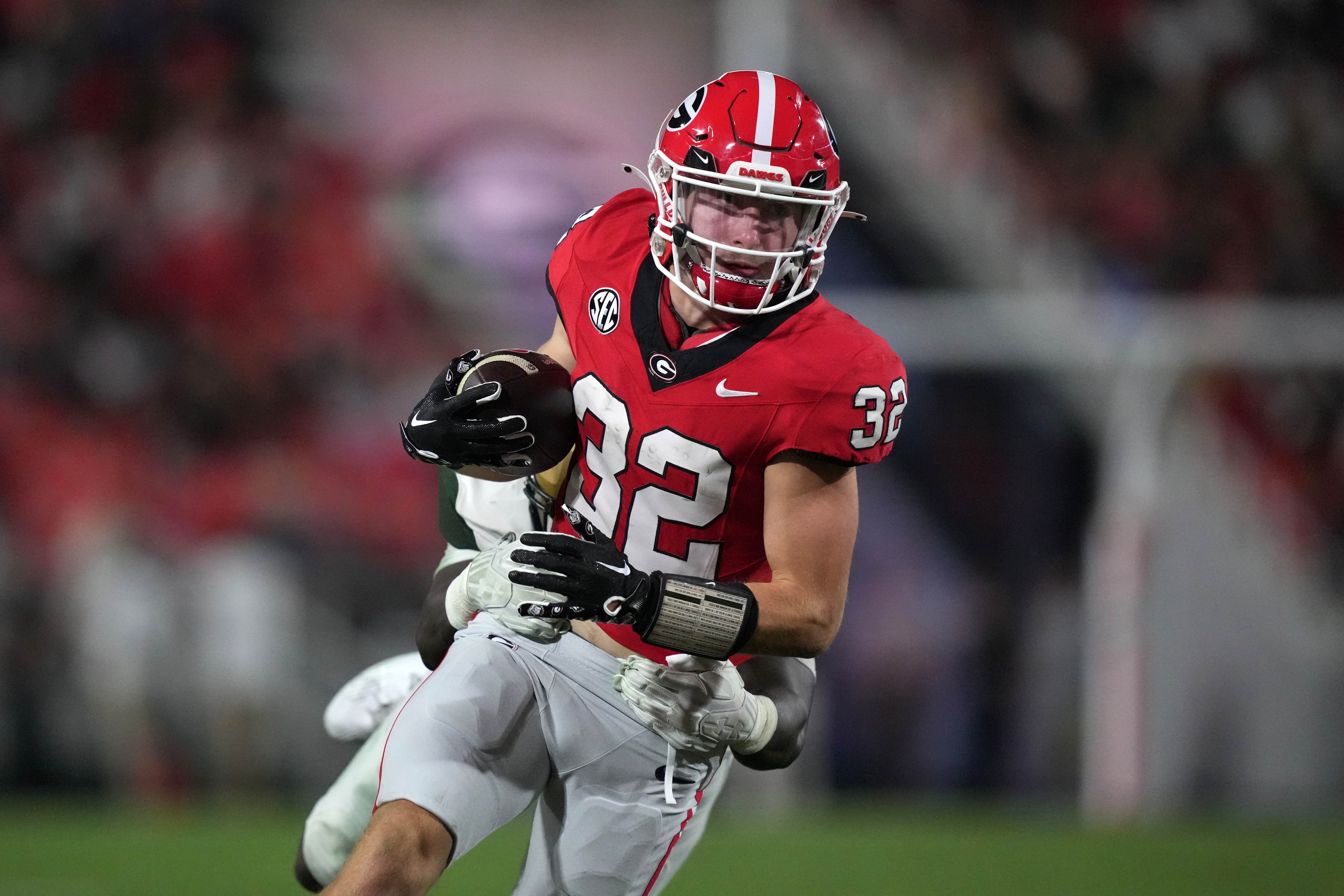 Georgia Bulldogs running back Cash Jones (32) carries the ball against UAB Blazers linebacker Everett Roussaw Jr. (27) in the first half at Sanford Stadium.