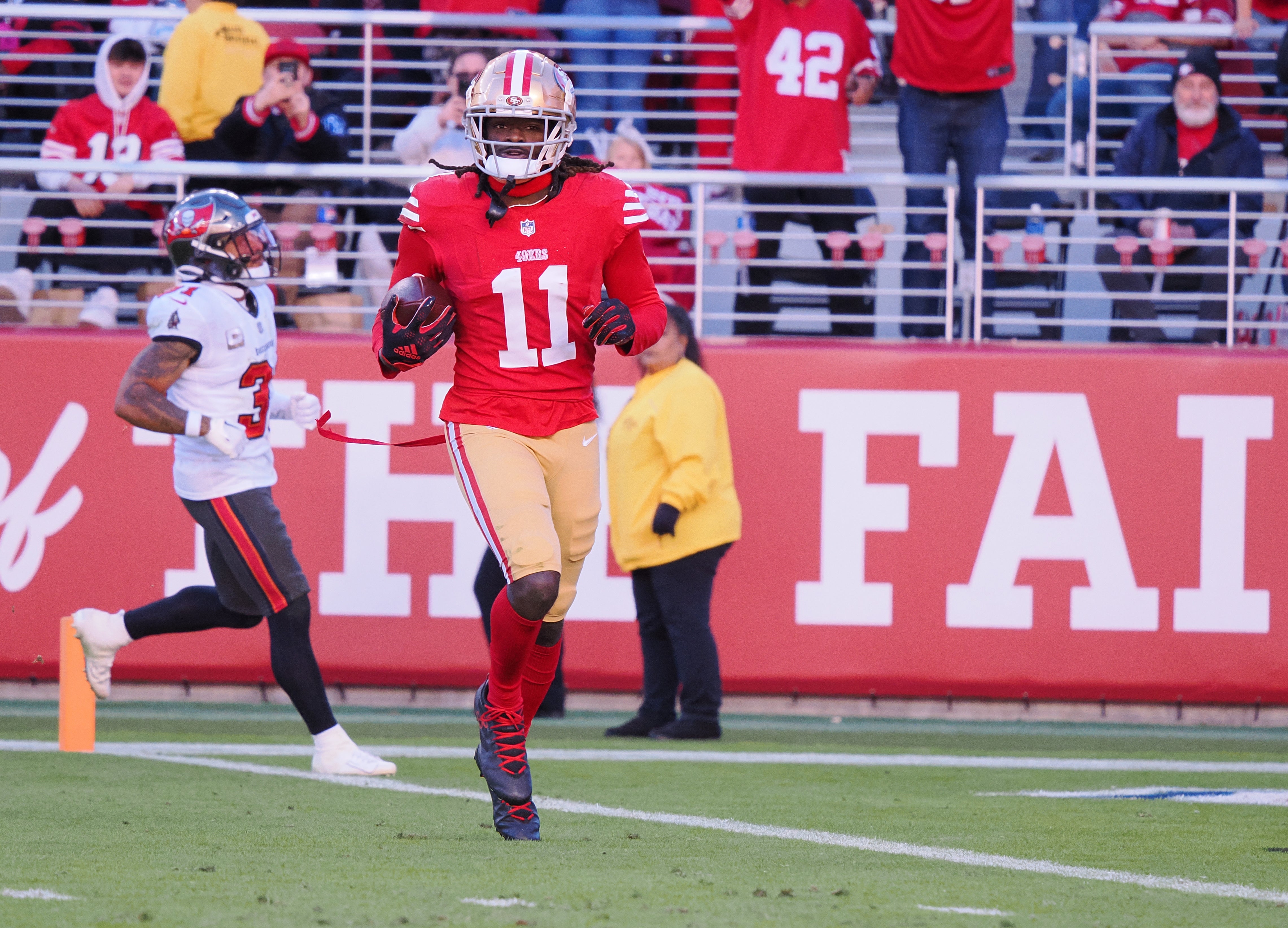 Nov 19, 2023; Santa Clara, California, USA; San Francisco 49ers wide receiver Brandon Aiyuk (11) runs after a catch for a 76-yard touchdown against the Tampa Bay Buccaneers during the third quarter at Levi's Stadium.