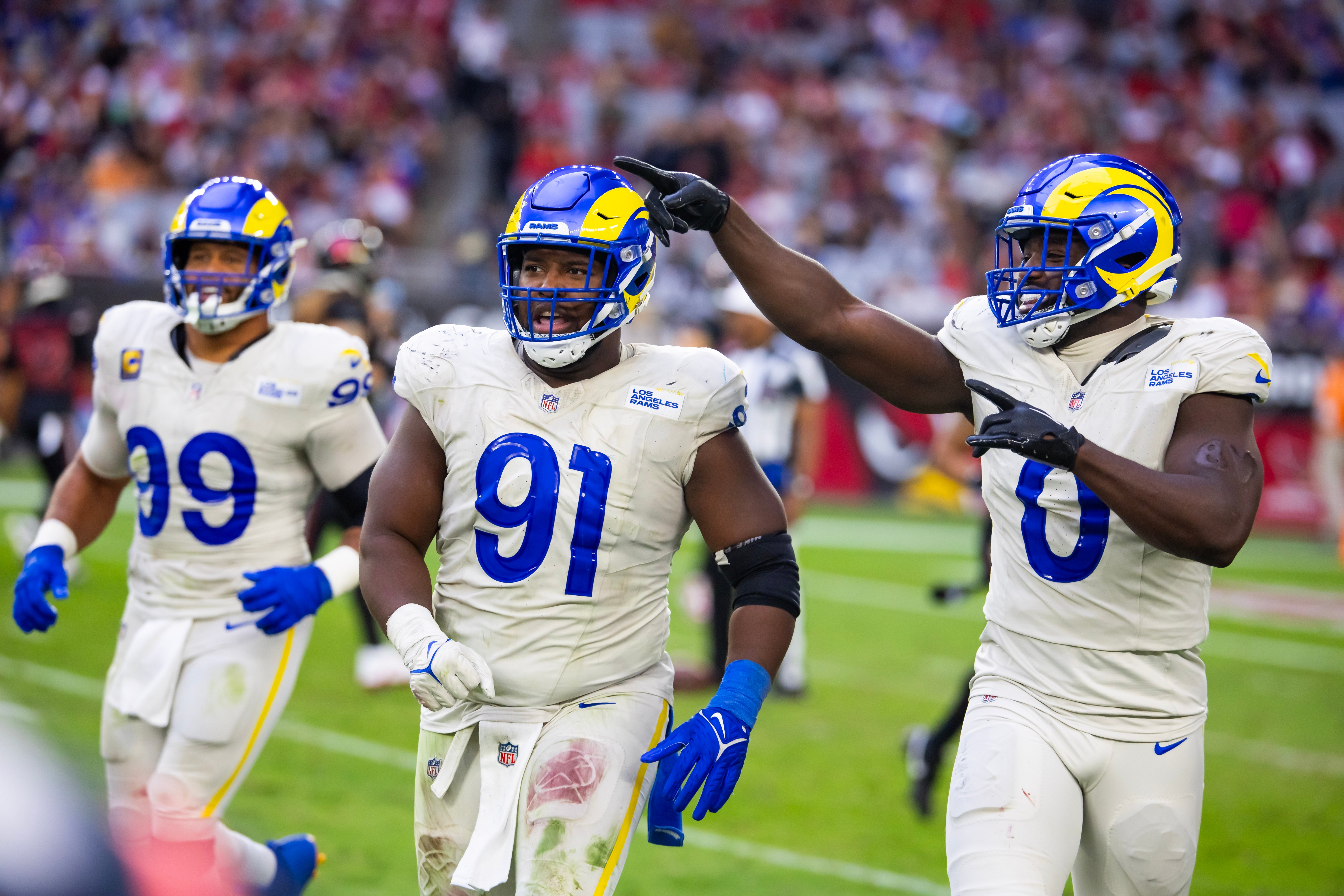 Nov 26, 2023; Glendale, Arizona, USA; Los Angeles Rams defensive tackle Kobie Turner (91) with linebacker Byron Young (0) and defensive tackle Aaron Donald (99) against the Arizona Cardinals at State Farm Stadium. Mandatory Credit: Mark J. Rebilas-USA TODAY Sports