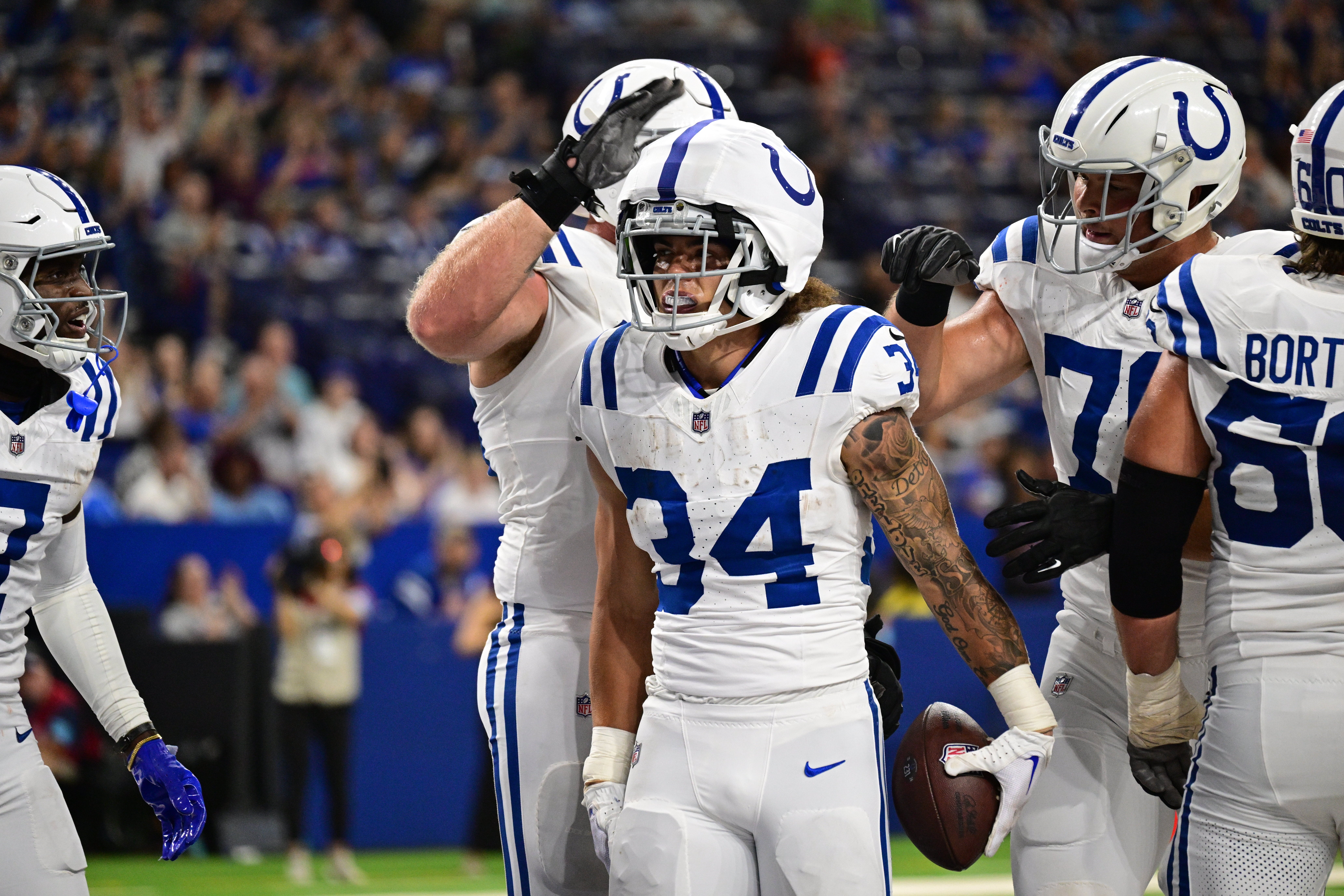 Aug 17, 2024; Indianapolis, Indiana, USA; Indianapolis Colts running back Zavier Scott (34) celebrates a touchdown during the second half against the Arizona Cardinals at Lucas Oil Stadium.