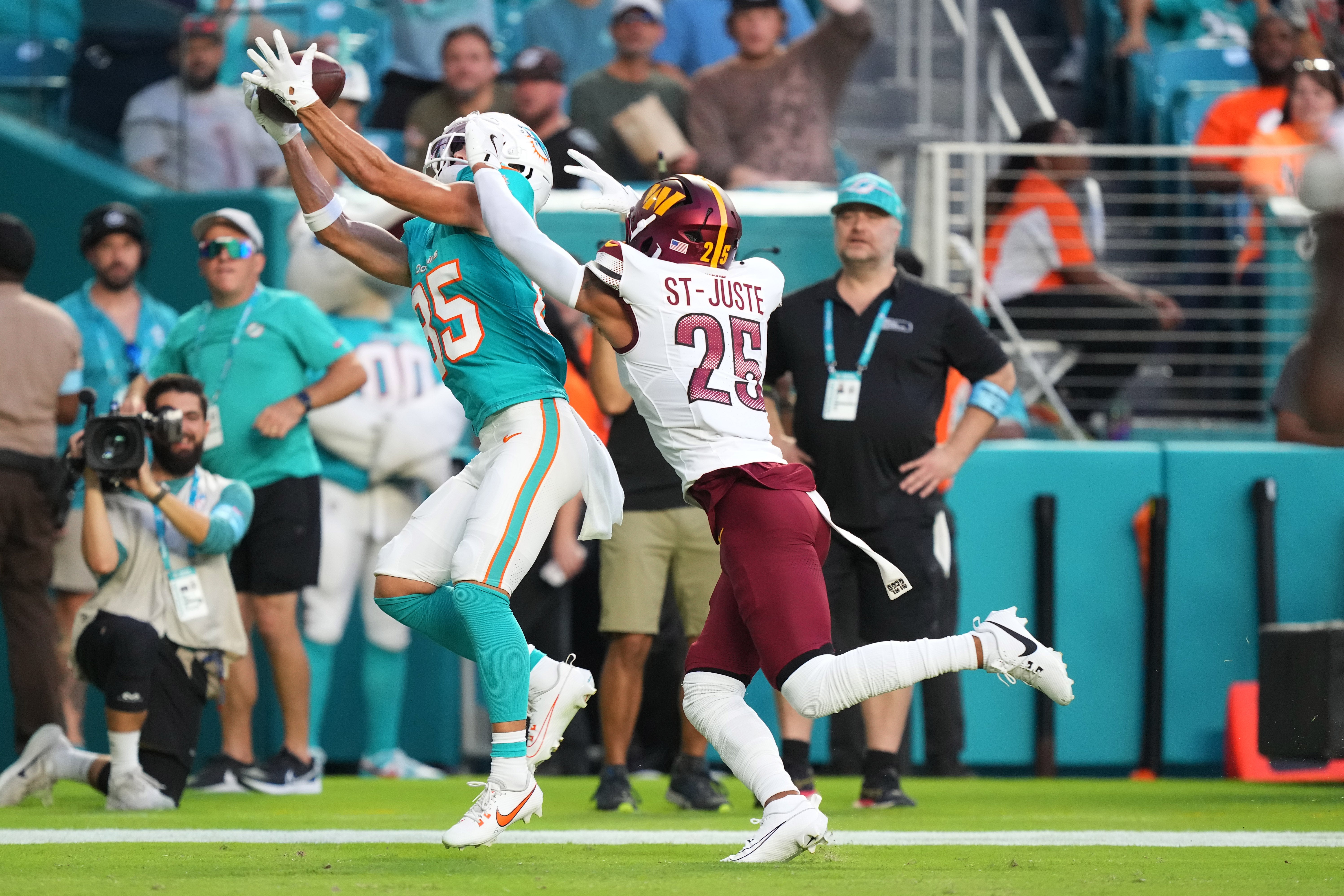 Aug 17, 2024; Miami Gardens, Florida, USA; Miami Dolphins wide receiver River Cracraft (85) catches a touchdown over Washington Commanders cornerback Benjamin St-Juste (25) during the first quarter at Hard Rock Stadium.