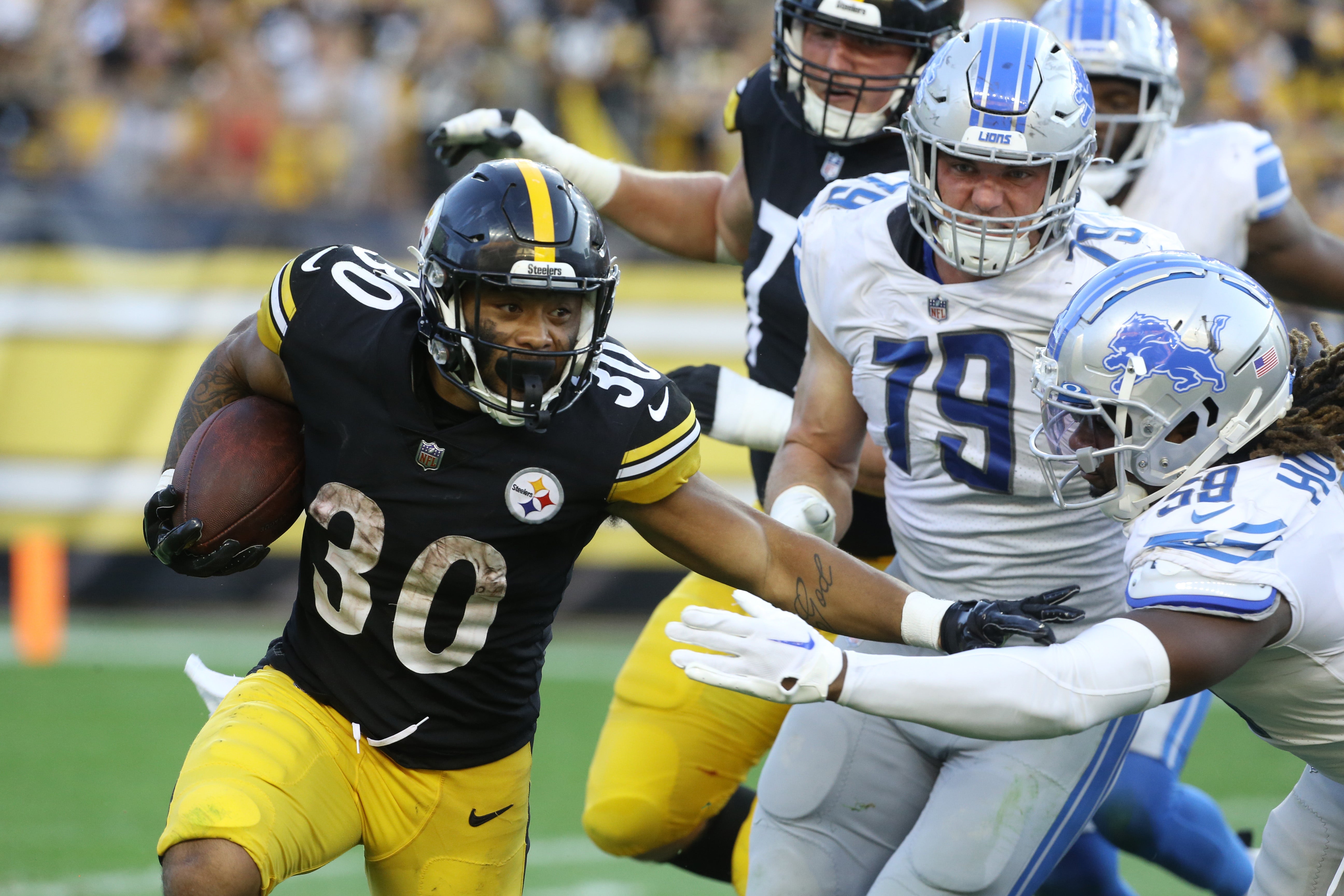 Aug 28, 2022; Pittsburgh, Pennsylvania, USA; Pittsburgh Steelers running back Jaylen Warren (30) runs the ball against Detroit Lions defensive end John Cominsky (79) and linebacker James Houston (59) during the fourth quarter Acrisure Stadium. Pittsburgh won 19-9. Mandatory Credit: Charles LeClaire-USA TODAY Sports