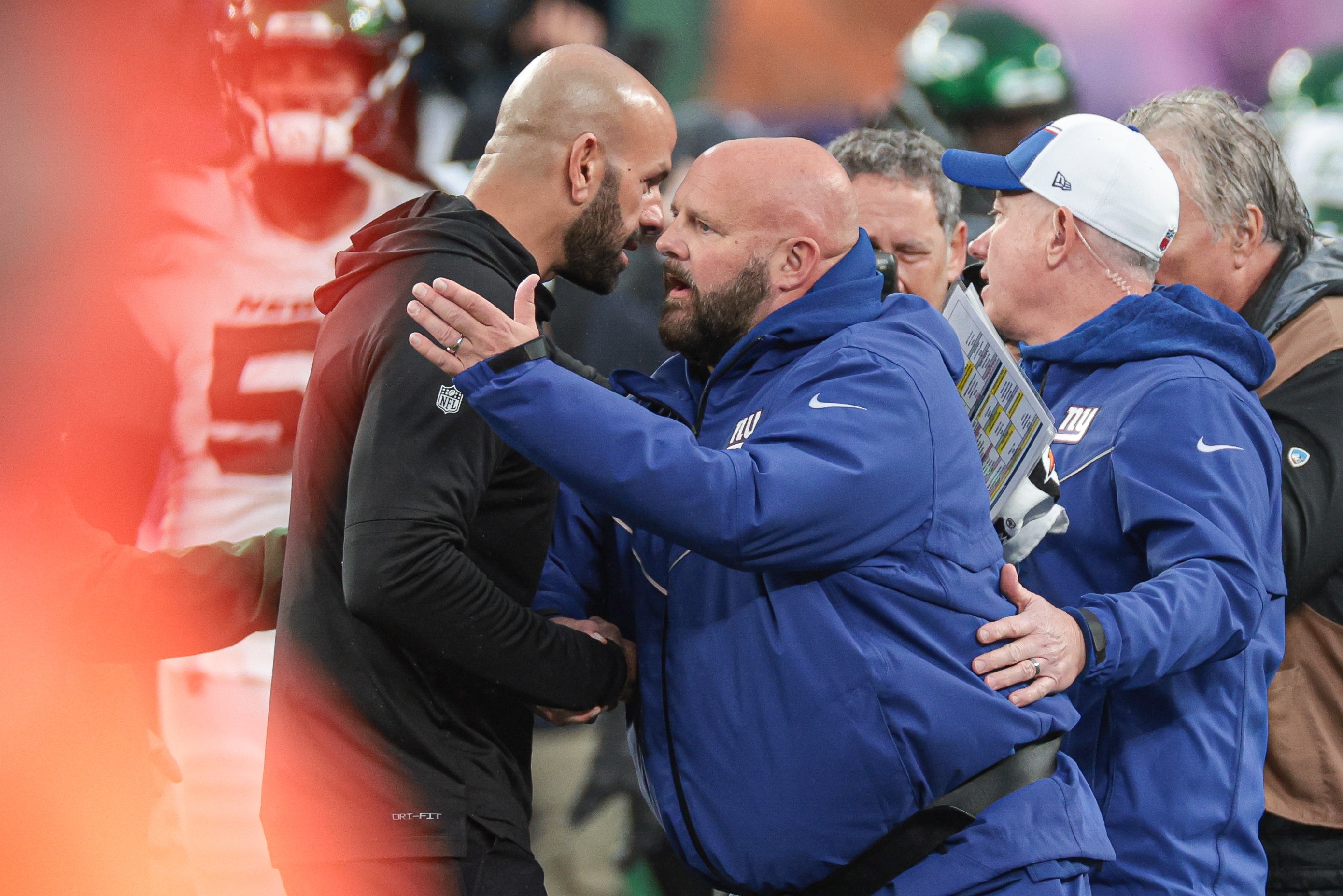 New York Jets head coach Robert Saleh meets with New York Giants head coach Brian Daboll after their game at MetLife Stadium.