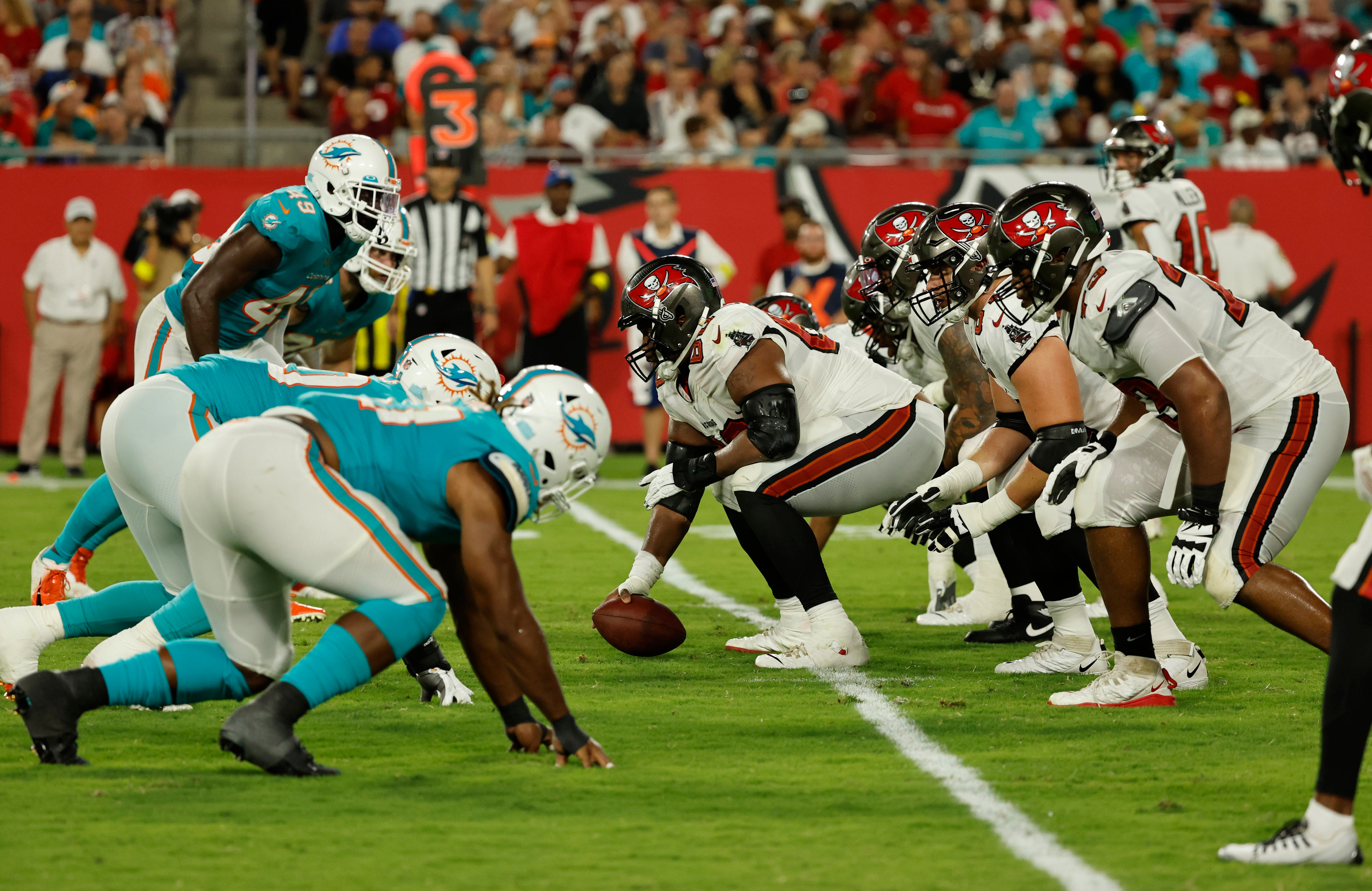 Aug 13, 2022; Tampa, Florida, USA; Tampa Bay Buccaneers guard Nick Leverett (60) gets ready to hike the ball with the offensive like and Miami Dolphins defensive line at the line of scrimmage during the second quarter at Raymond James Stadium.