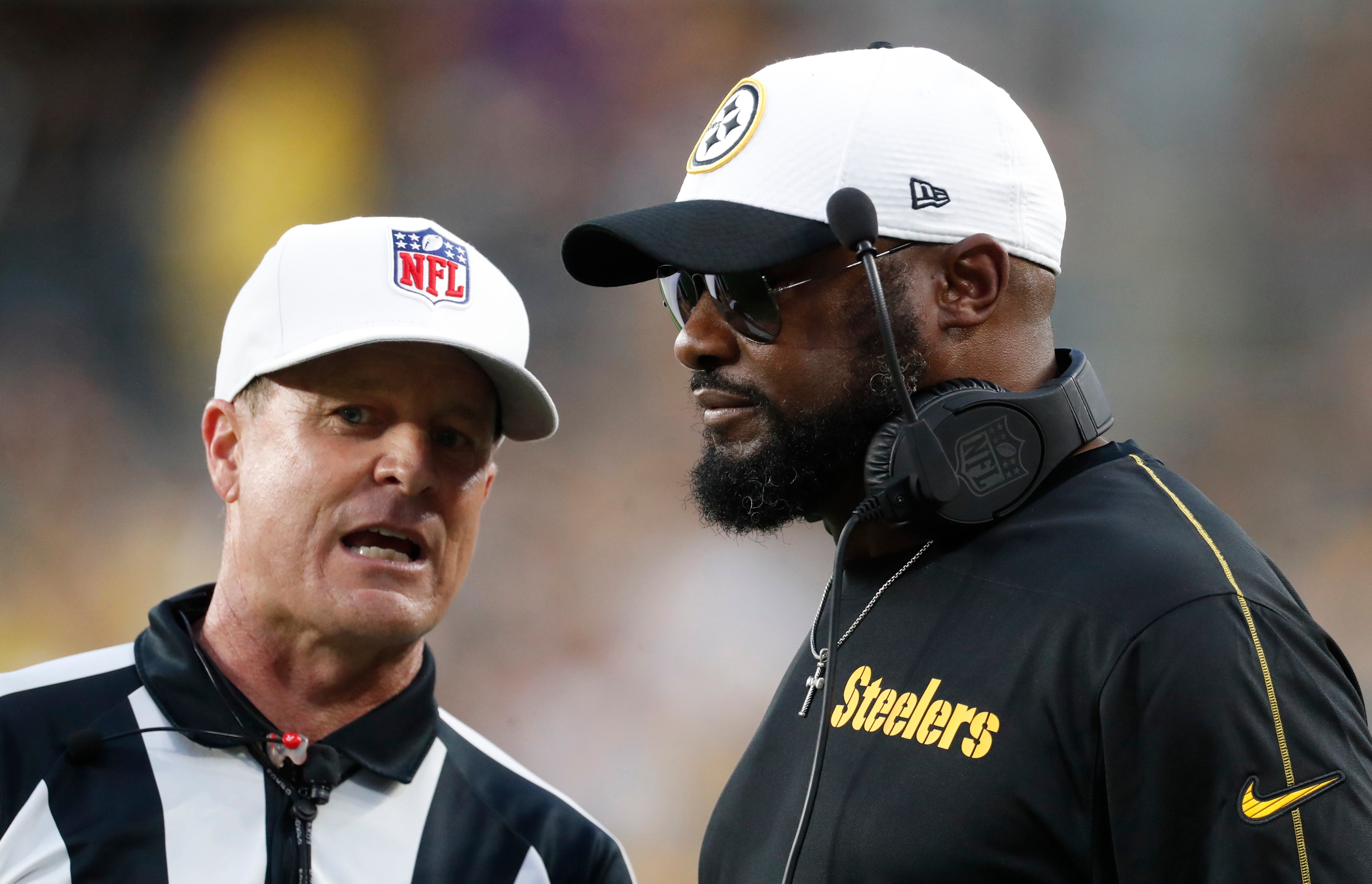 Aug 17, 2024; Pittsburgh, Pennsylvania, USA; Pittsburgh Steelers head coach Mike Tomlin (right) listens to referee Shawn Hochuli (83) against the Buffalo Bills during the second quarter at Acrisure Stadium. Mandatory Credit: Charles LeClaire-USA TODAY Sports