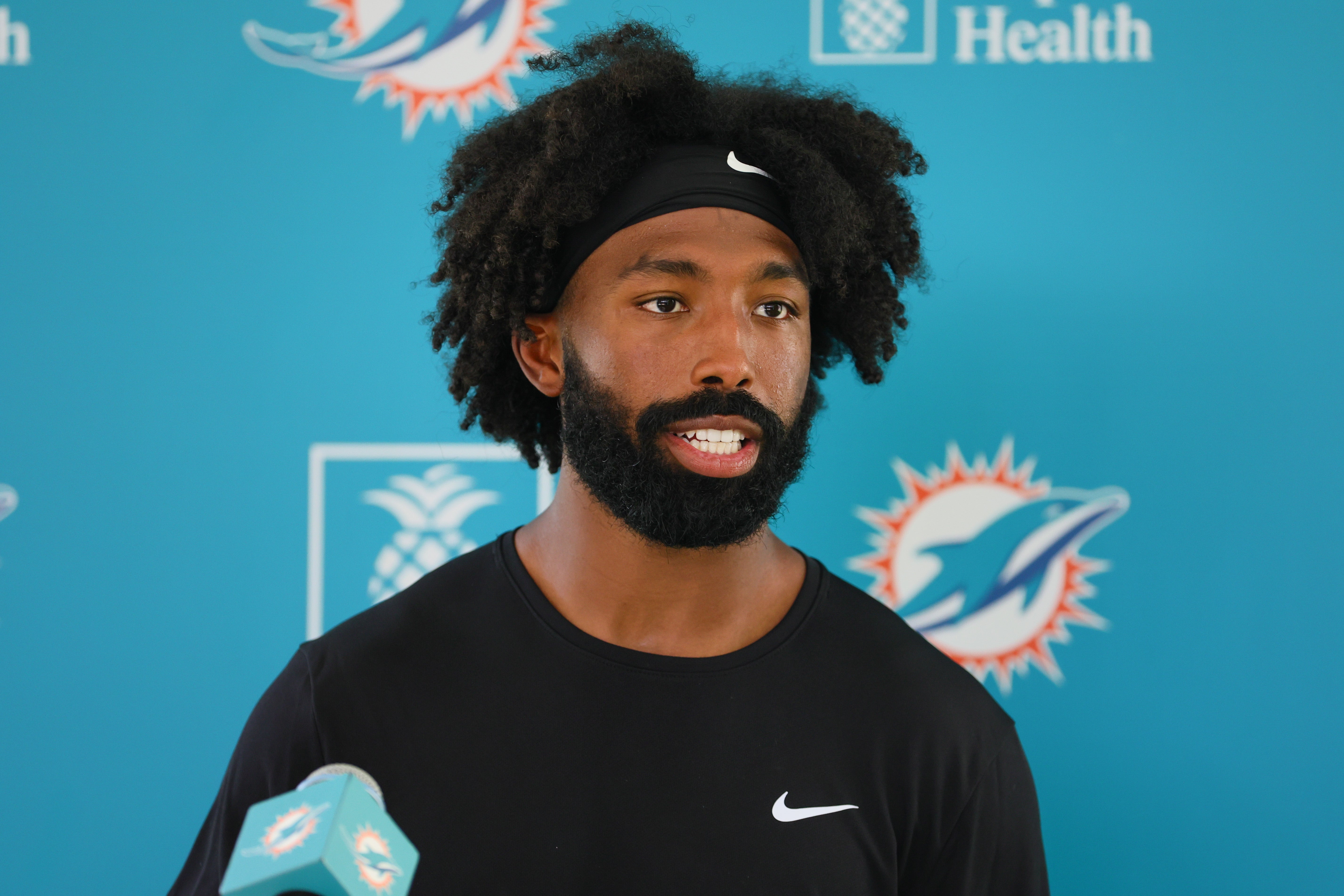Aug 15, 2024; Miami Gardens, FL, USA; Miami Dolphins running back Salvon Ahmed (26) talks to reporters after joint practice with the Washington Commanders at Baptist Health Training Complex.