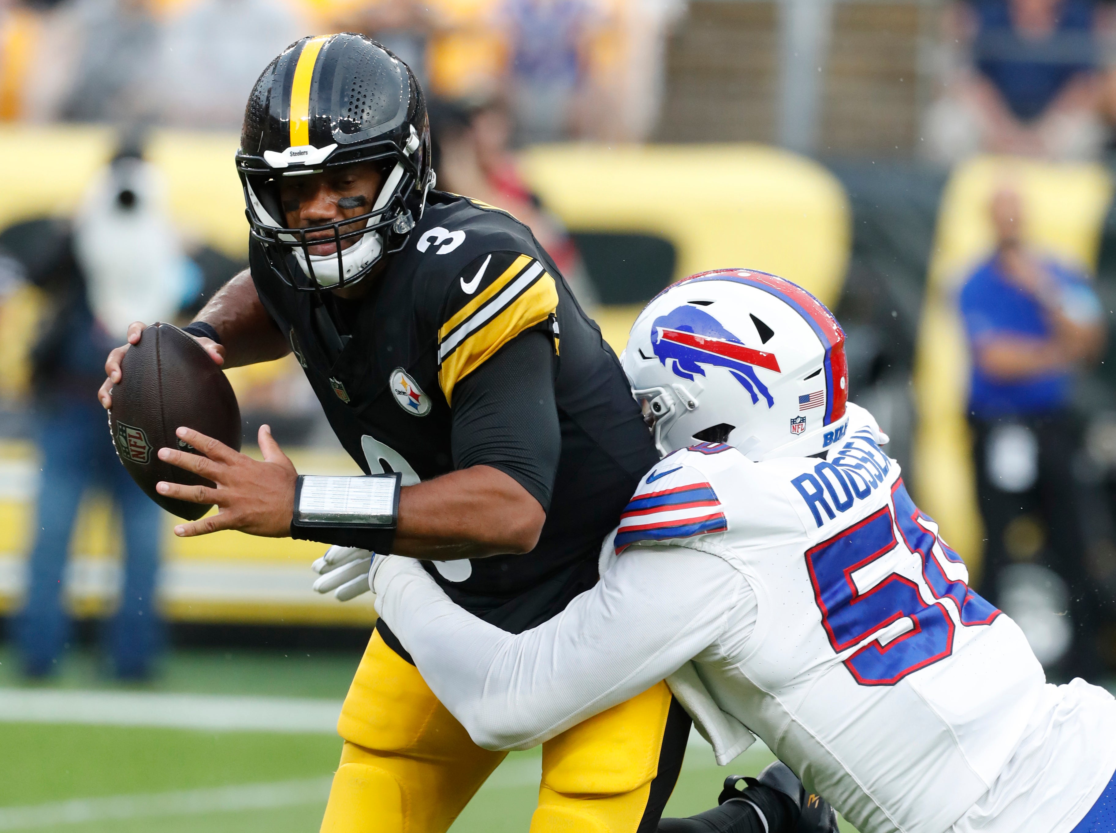 Aug 17, 2024; Pittsburgh, Pennsylvania, USA; Buffalo Bills defensive end Greg Rousseau (50) sacks Pittsburgh Steelers quarterback Russell Wilson (3) during the first quarter at Acrisure Stadium. Mandatory Credit: Charles LeClaire-USA TODAY Sports  