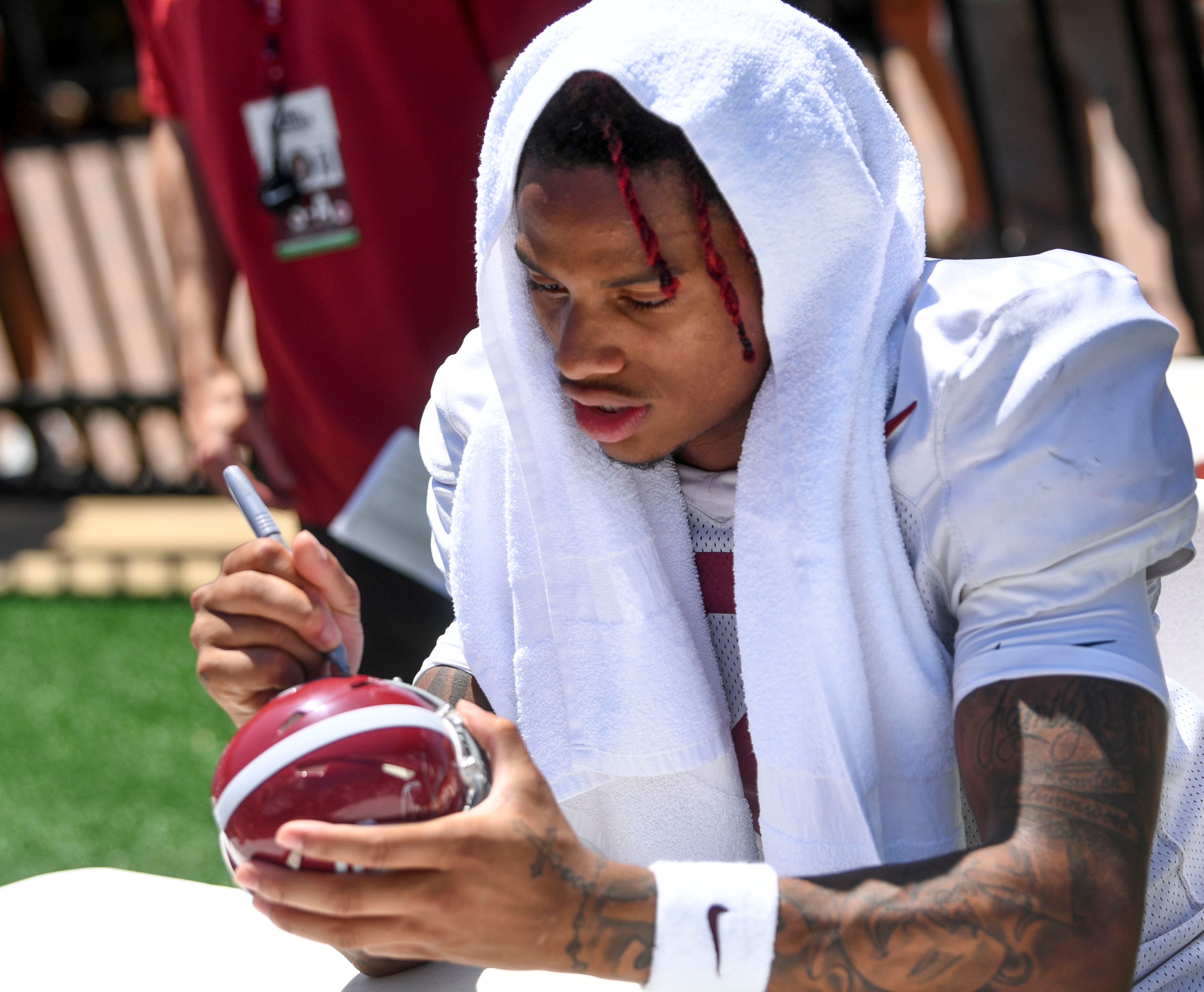 Fans have a chance to get autographs from players and Coach Kalen DeBoer at Bryant-Denny Stadium Sunday, Aug. 11, 2024, during Fan Day. Alabama wide receiver Ryan Williams (2) signs a helmet.