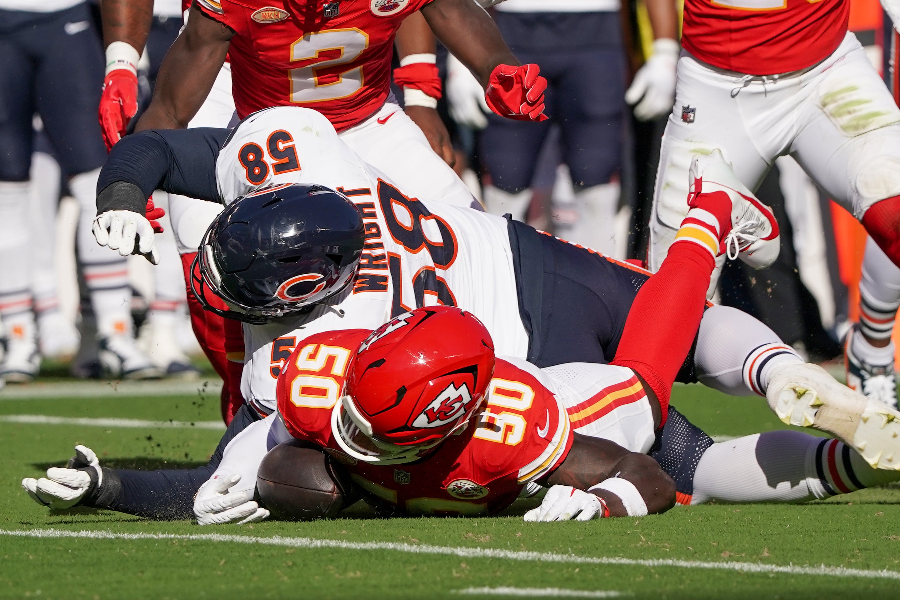 Sep 24, 2023; Kansas City, Missouri, USA; Kansas City Chiefs linebacker Willie Gay (50) recovers a fumble as Chicago Bears offensive tackle Darnell Wright (58) defends during the first half at GEHA Field at Arrowhead Stadium.