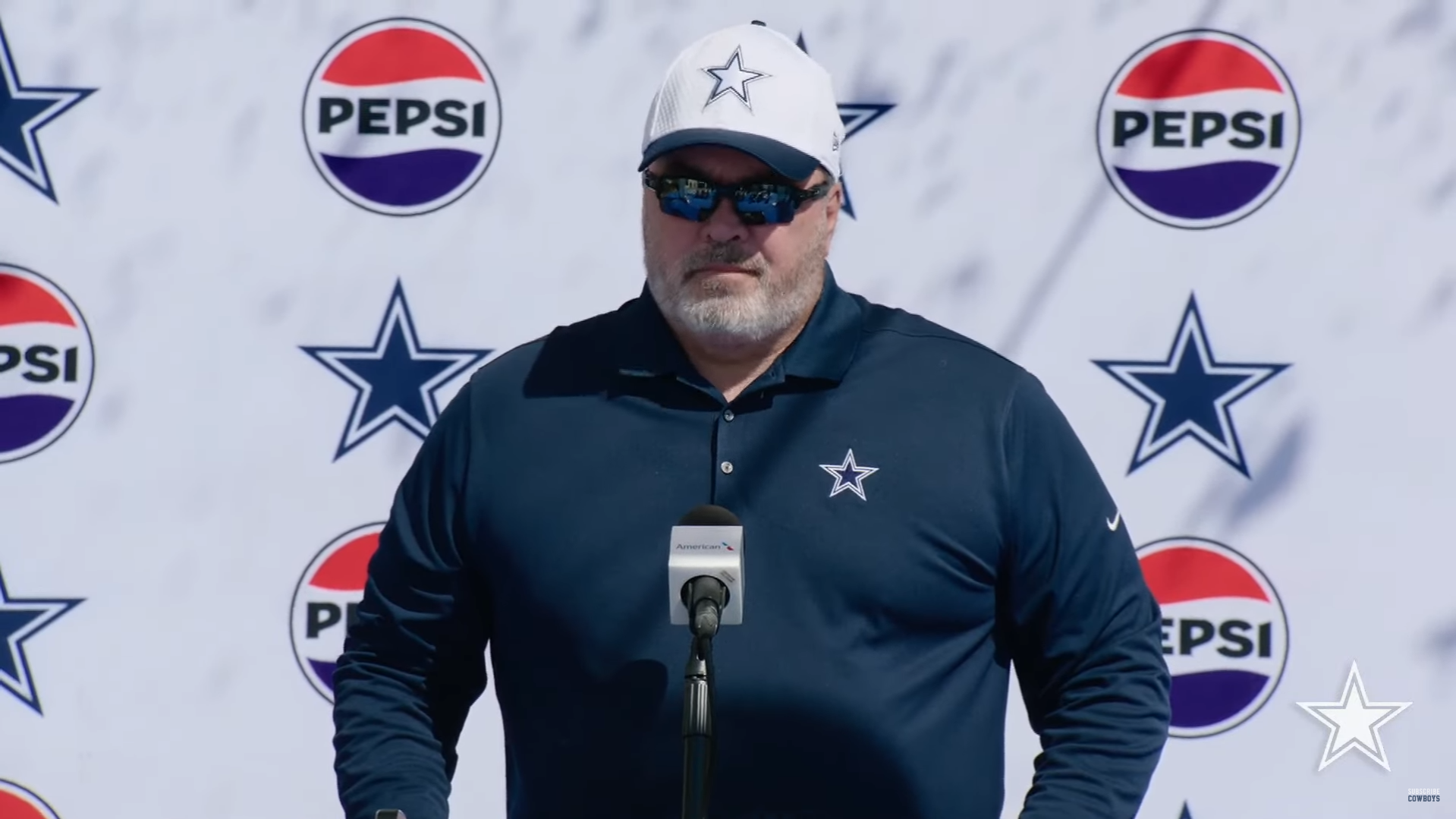 Dallas Cowboys HC Mike McCarthy talks to reporters at 2024 training camp.