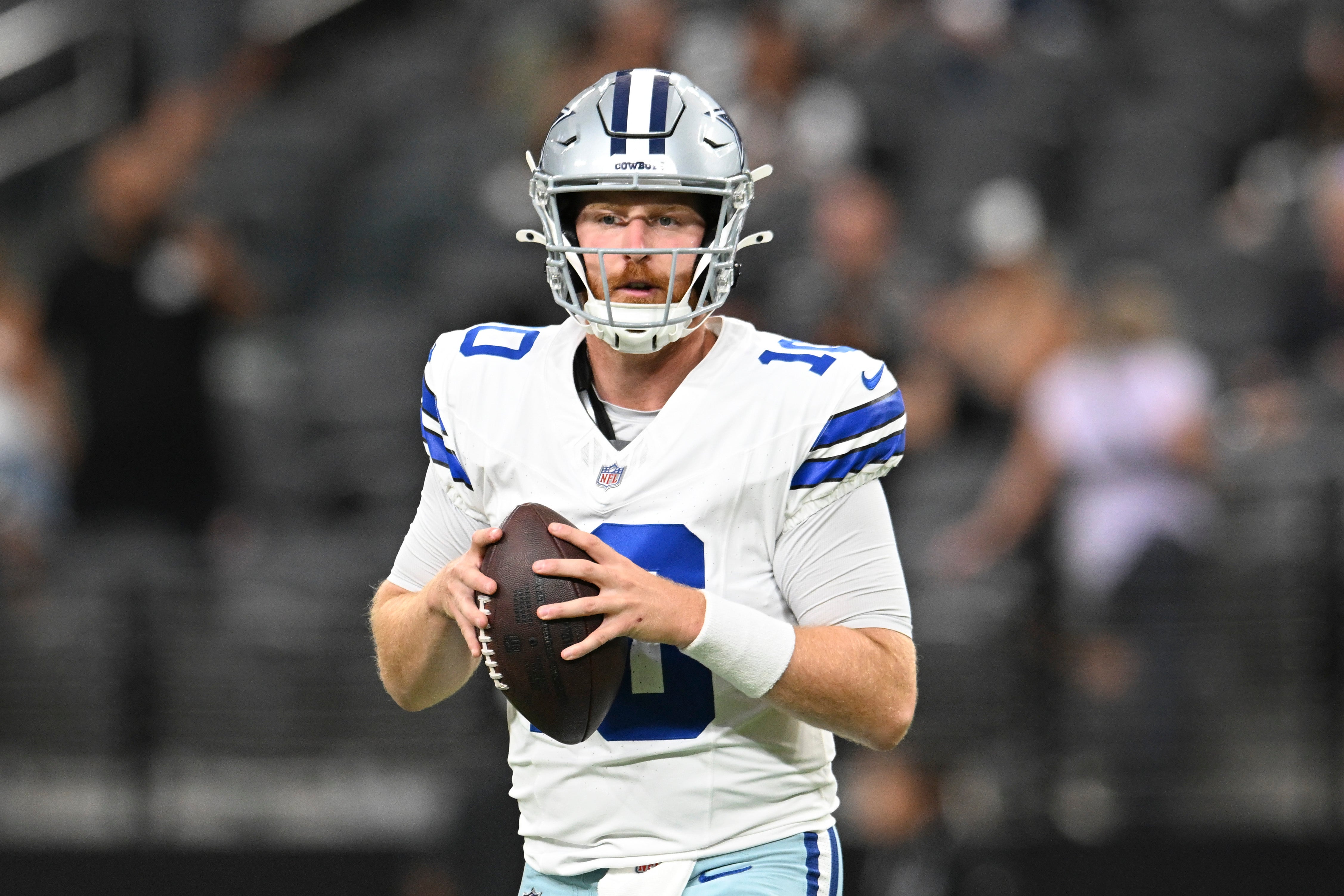 Dallas Cowboys quarterback Cooper Rush (10) warms up against the Las Vegas Raiders at Allegiant Stadium.