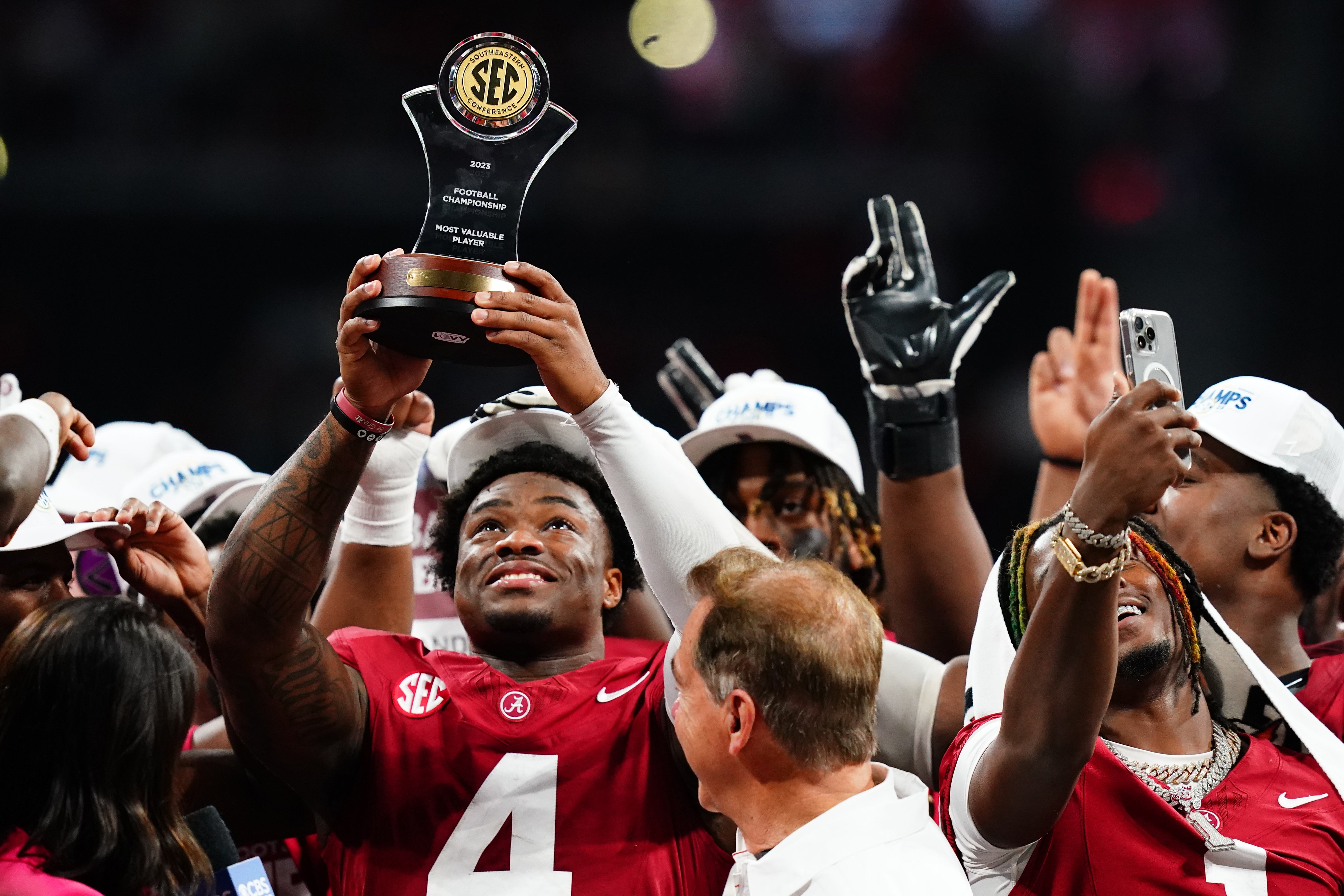 Jalen Milroe lifts the SEC Championship trophy
