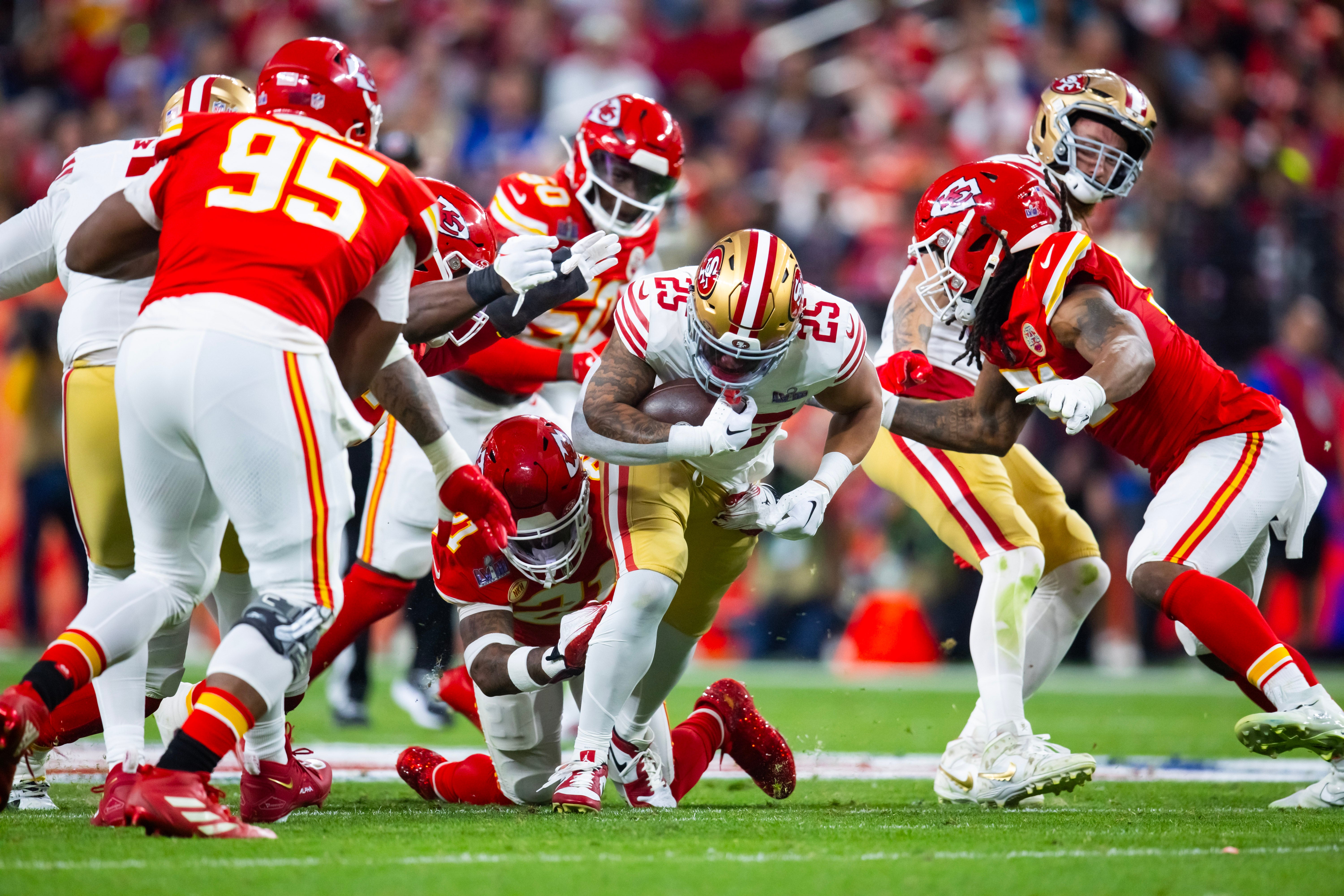 Feb 11, 2024; Paradise, Nevada, USA; San Francisco 49ers running back Elijah Mitchell (25) is tackled by Kansas City Chiefs safety Mike Edwards (21) in the first half in Super Bowl LVIII at Allegiant Stadium.