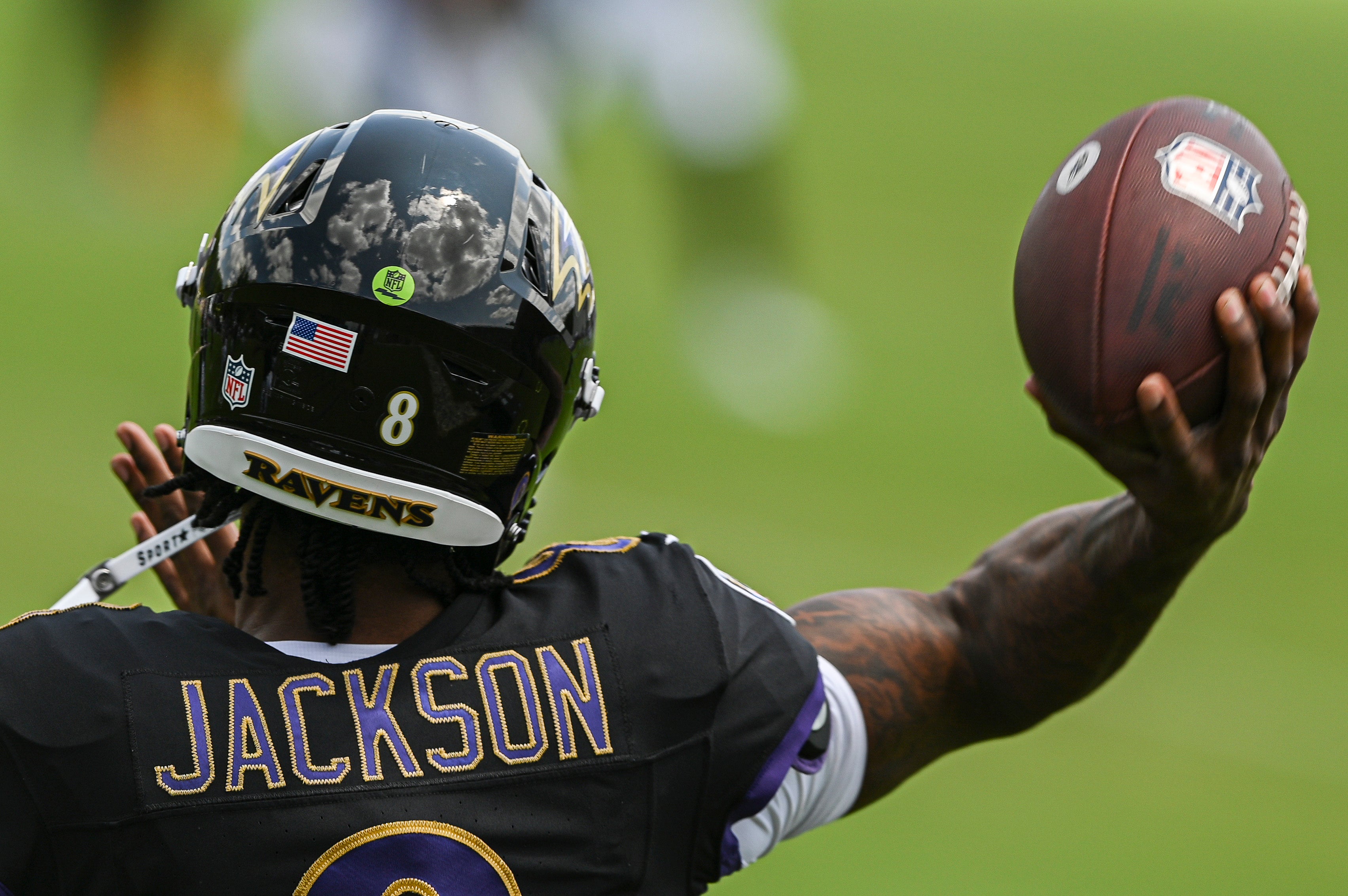 Jul 27, 2024; Owings Mill , MD, USA; Clouds reflect off Baltimore Ravens quarterback Lamar Jackson helmet during passing drill in the afternoon session of training camp at the Under Armour Performance Center, Mandatory Credit: Tommy Gilligan-USA TODAY Sports