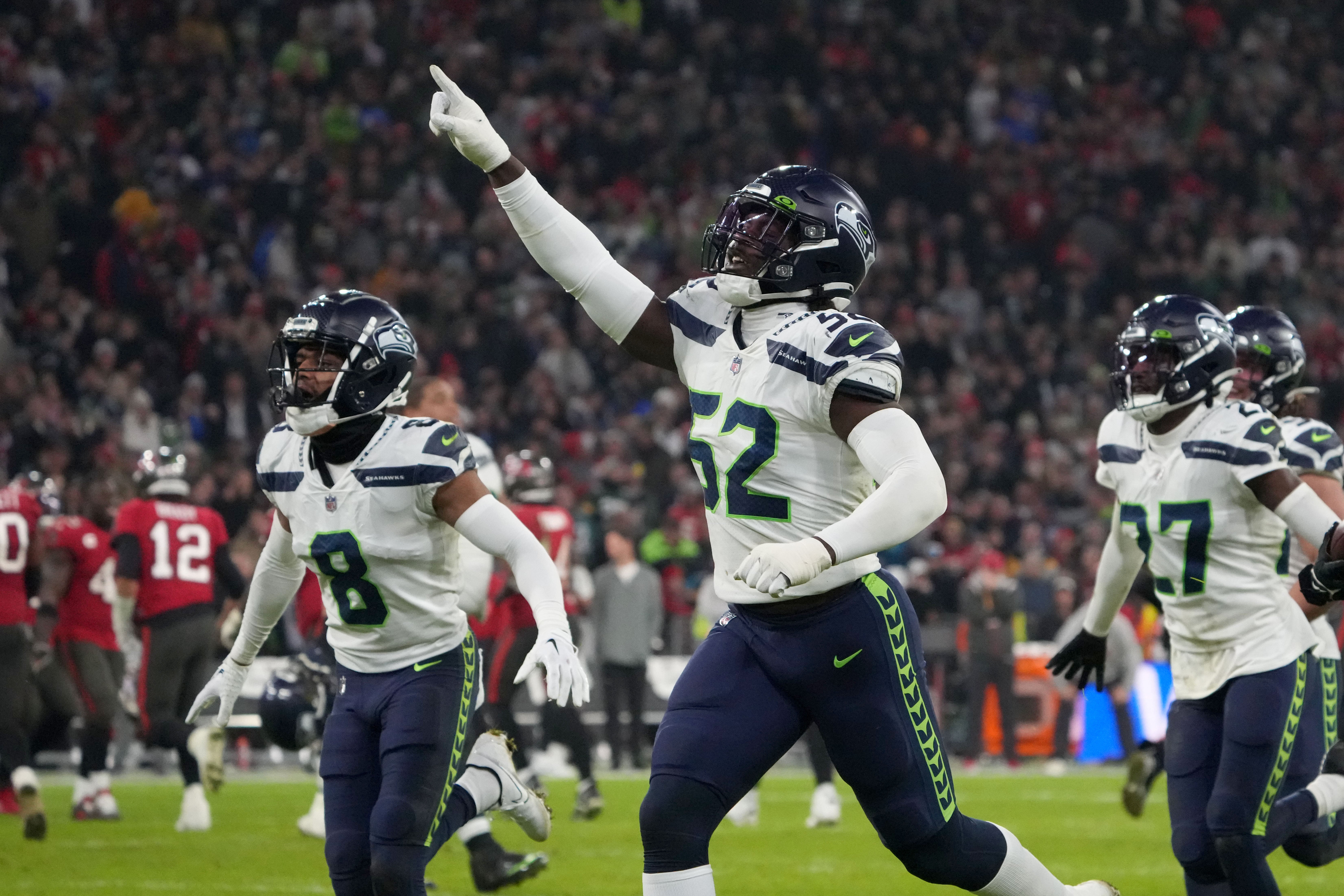 Nov 13, 2022; Munich, Germany; Seattle Seahawks cornerback Coby Bryant (8) and defensive end Darrell Taylor (52) celebrate after an interception in the second half against the Tampa Bay Buccaneers during an NFL International Series game at Allianz Arena.