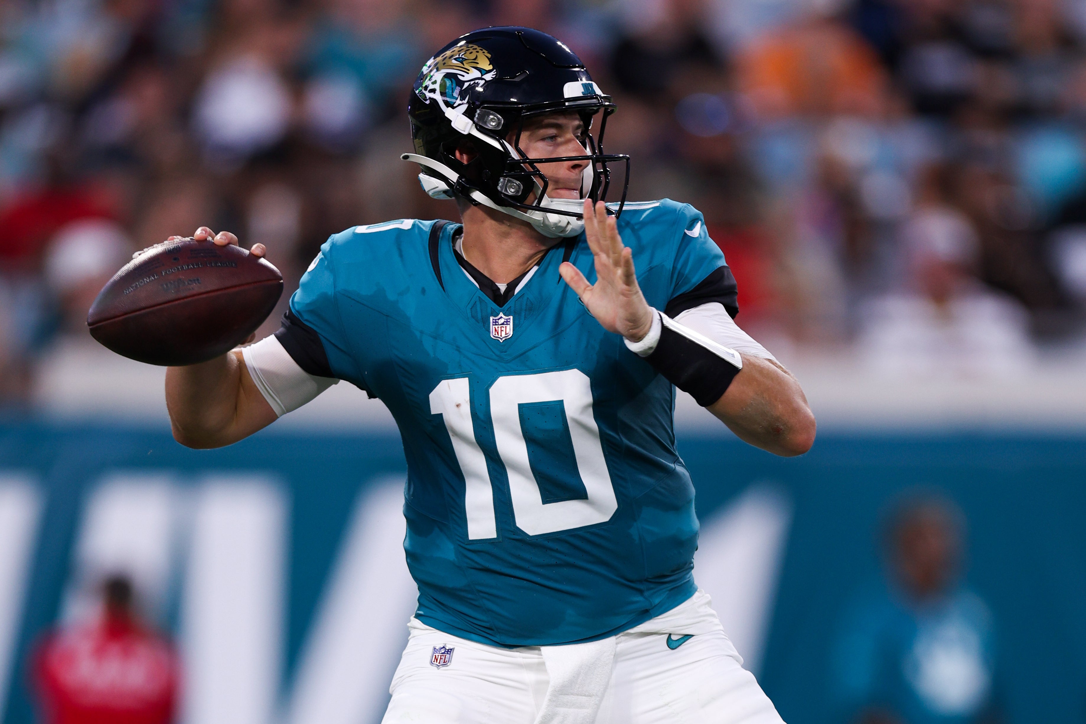 Aug 17, 2024; Jacksonville, Florida, USA; Jacksonville Jaguars quarterback Mac Jones (10) drops back to pass against the Tampa Bay Buccaneers in the first quarter during a preseason game at EverBank Stadium
