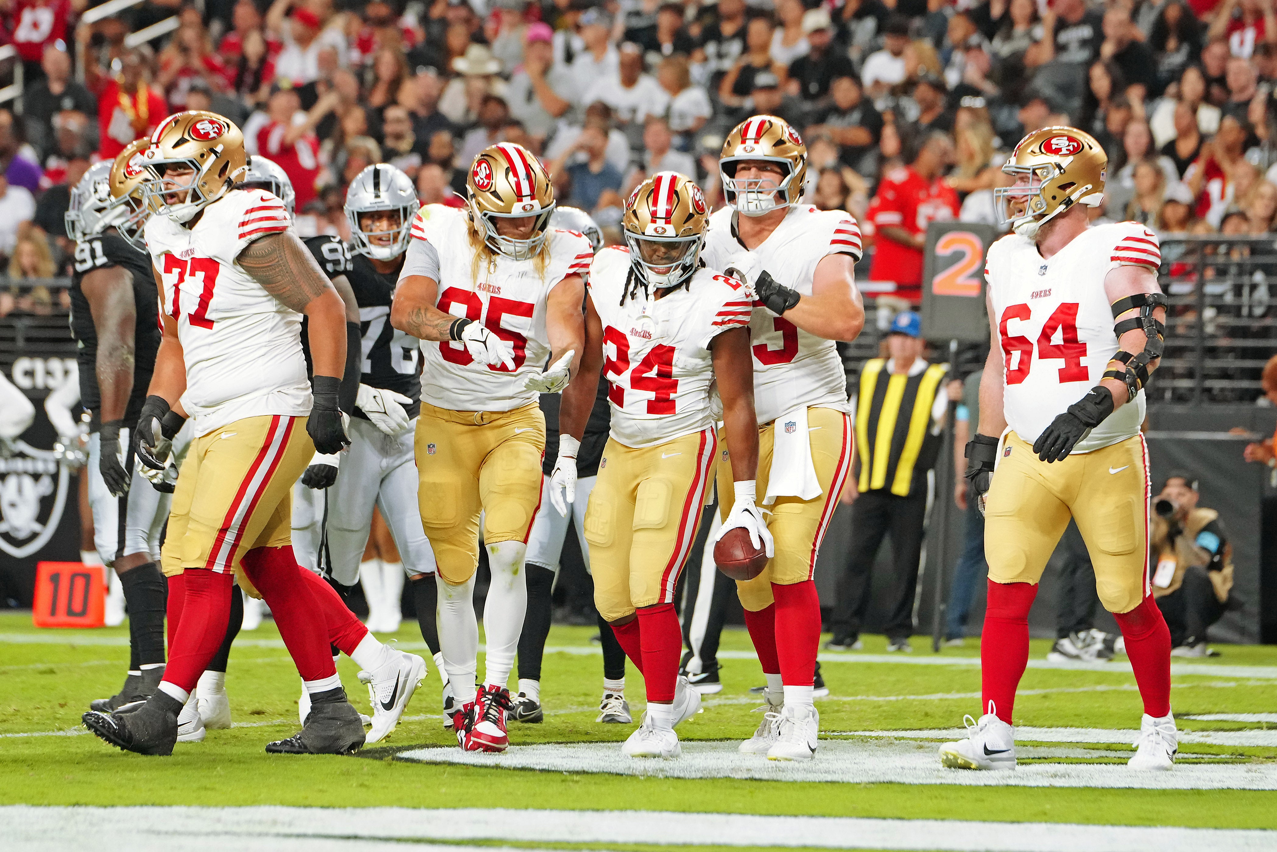 Aug 23, 2024; Paradise, Nevada, USA; San Francisco 49ers running back Jordan Mason (24) celebrates with team mates after scoring a touchdown against the Las Vegas Raiders during the first quarter at Allegiant Stadium.