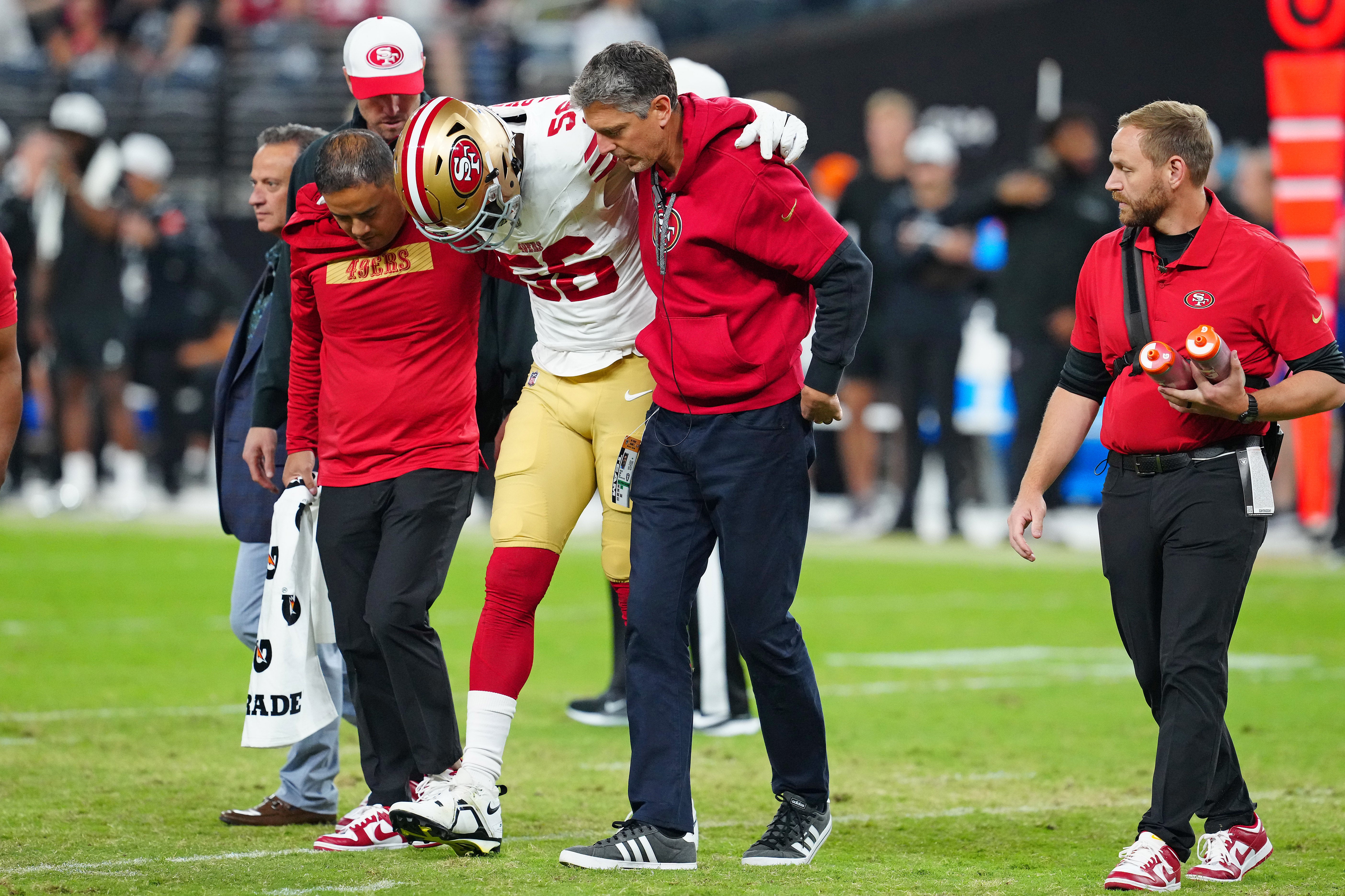 Aug 23, 2024; Paradise, Nevada, USA; San Francisco 49ers defensive end Leonard Floyd (56) is helped off the field after sustaining an apparent injury while playing against the Las Vegas Raiders during the first quarter at Allegiant Stadium.