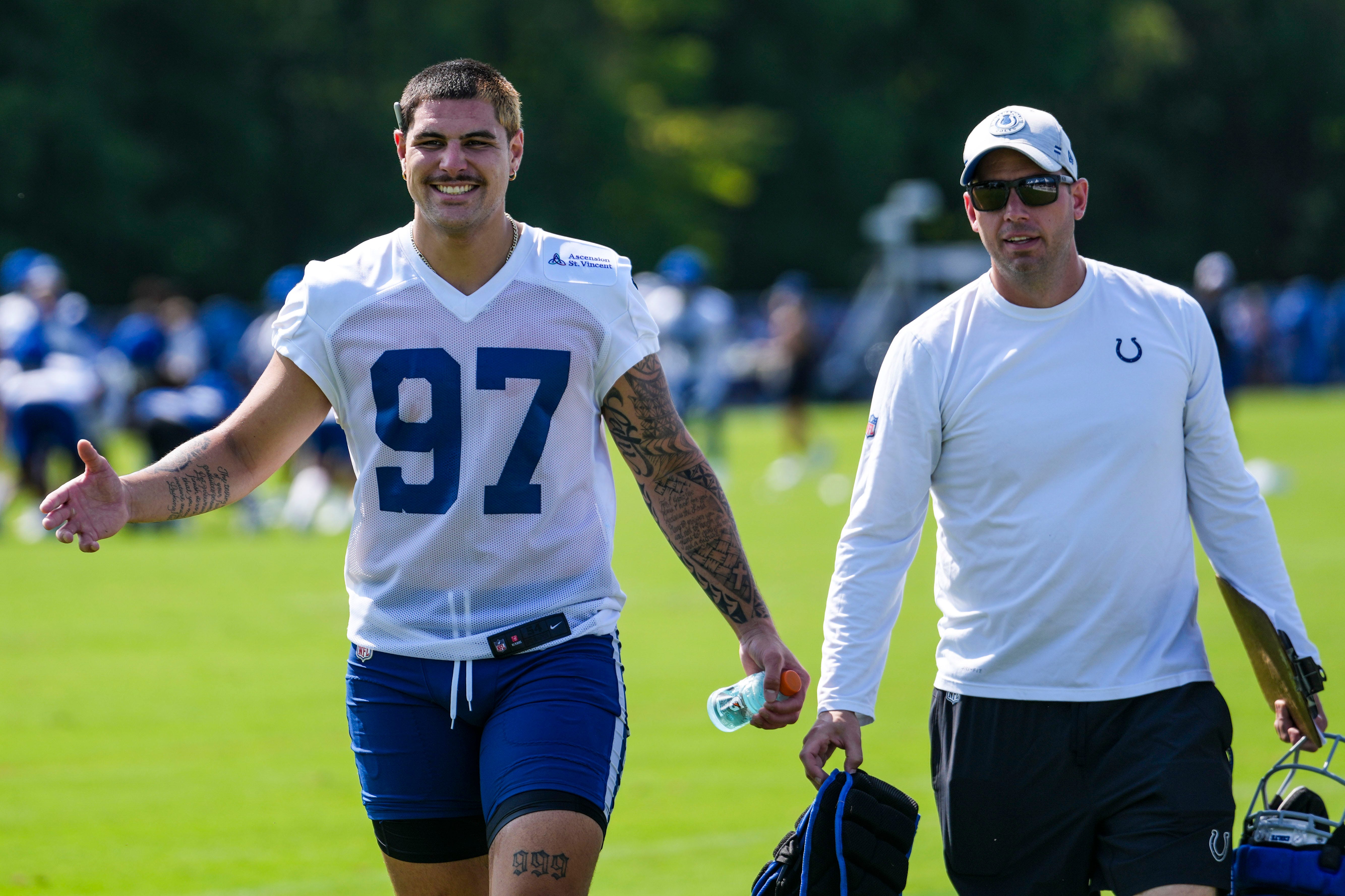 Indianapolis Colts defensive end Laiatu Latu (97) smiles while walking toward a member of the media Saturday, July 27, 2024, during the Indianapolis Colts’ training camp at Grand Park Sports Complex in Westfield.