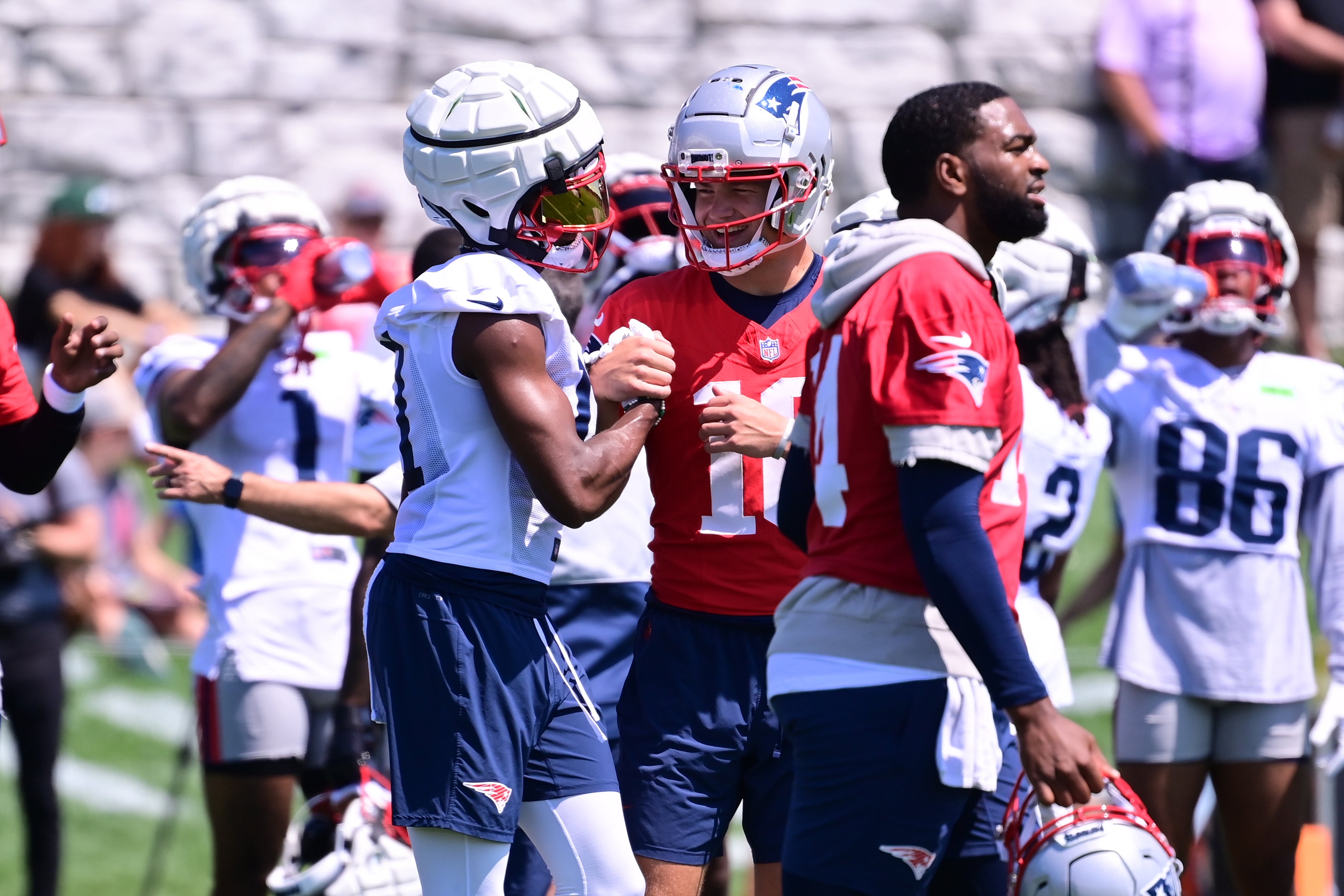 Jul 26, 2024; Foxborough, MA, USA; New England Patriots quarterback Drake Maye (10) reacts at end of a drill with wide receiver Tyquan Thornton (11) during training camp at Gillette Stadium.