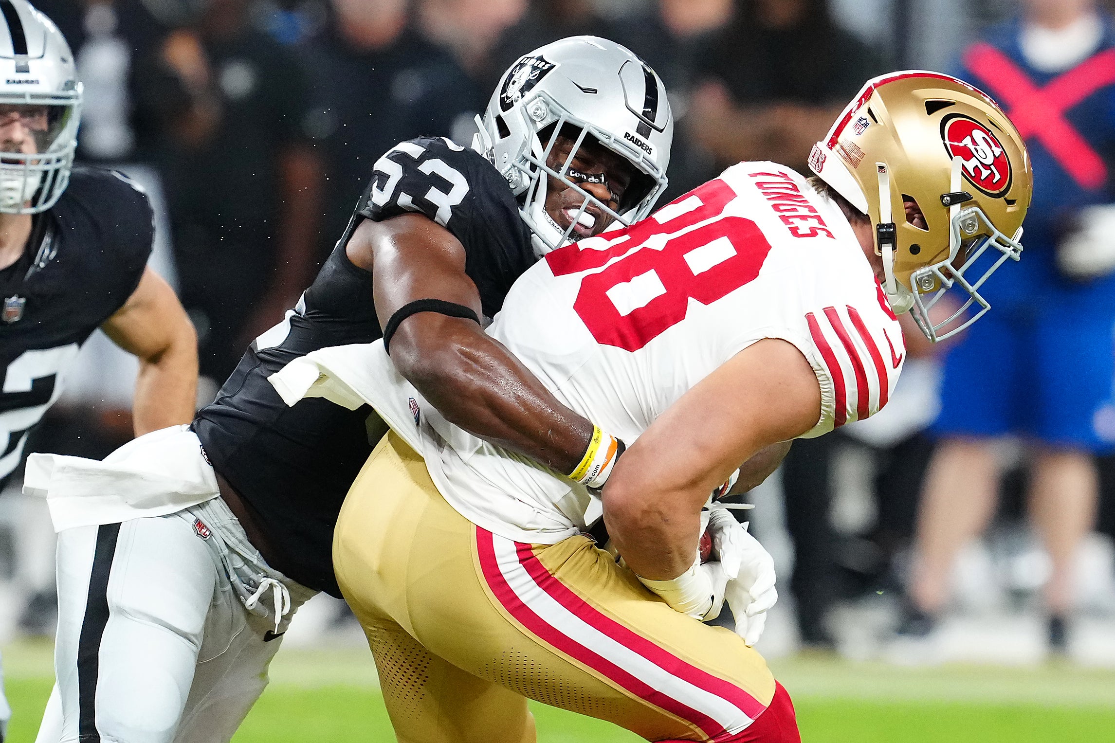 Aug 23, 2024; Paradise, Nevada, USA; Las Vegas Raiders linebacker Amari Gainer (53) tackles San Francisco 49ers tight end Jake Tonges (88) during the first quarter at Allegiant Stadium.