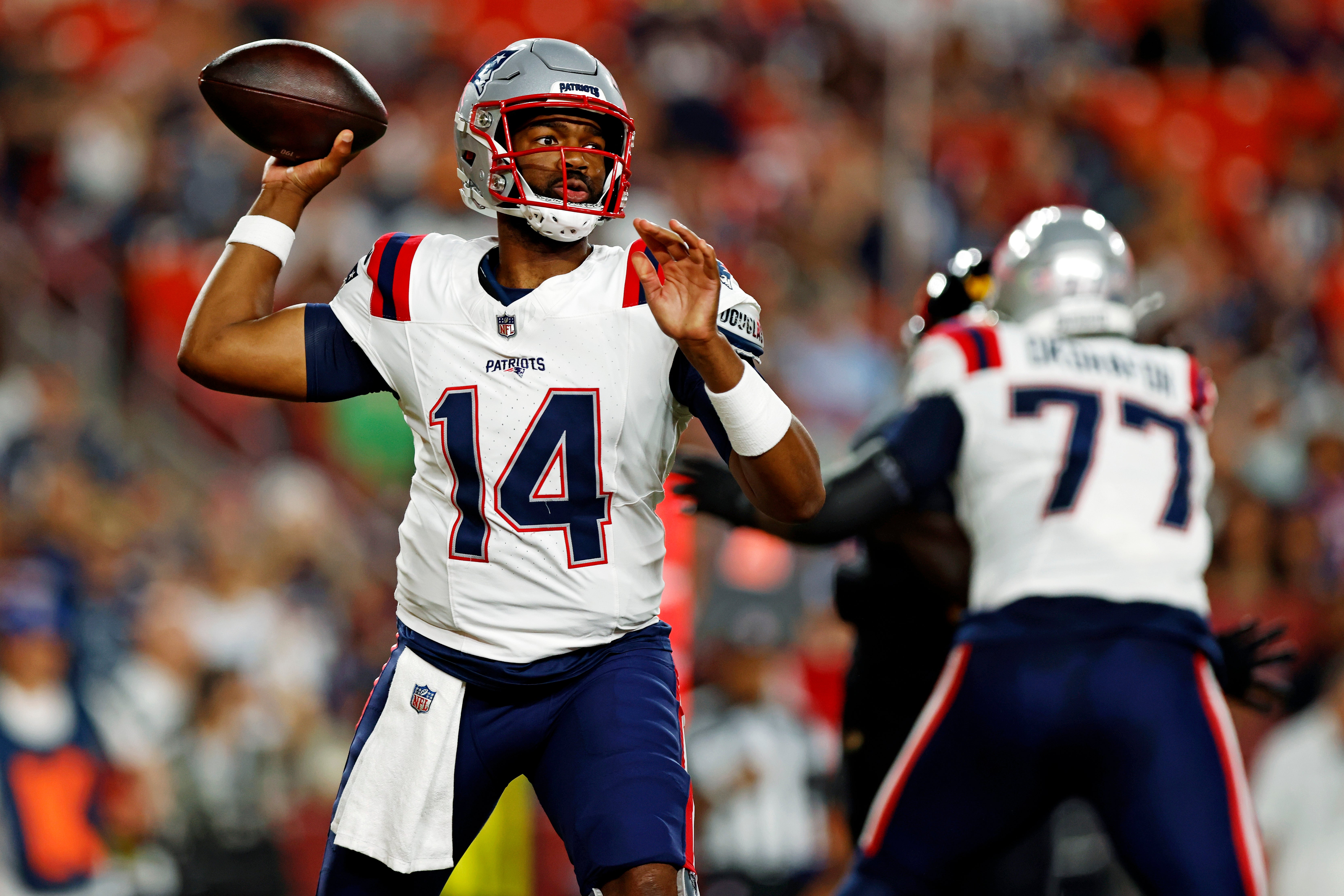 Aug 25, 2024; Landover, Maryland, USA; New England Patriots quarterback Jacoby Brissett (14) throws a pass during the first quarter against the Washington Commanders during a preseason game at Commanders Field
